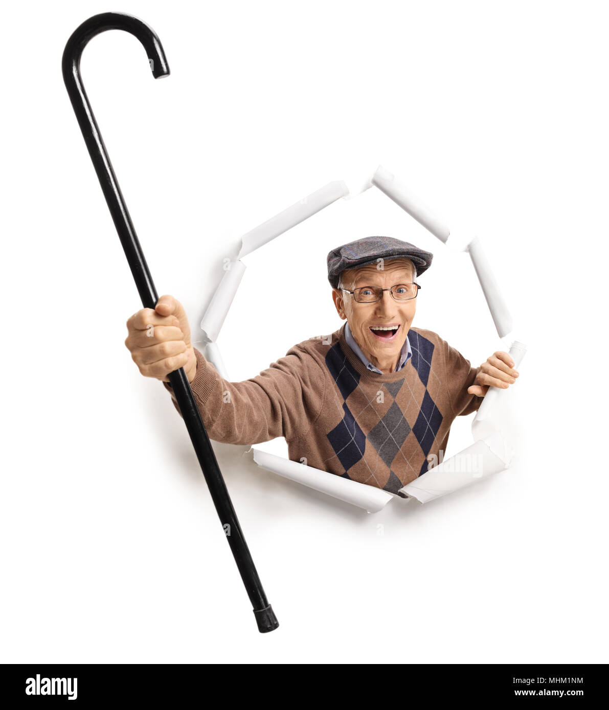 Cheerful homme âgé avec une canne Breaking through paper Banque D'Images