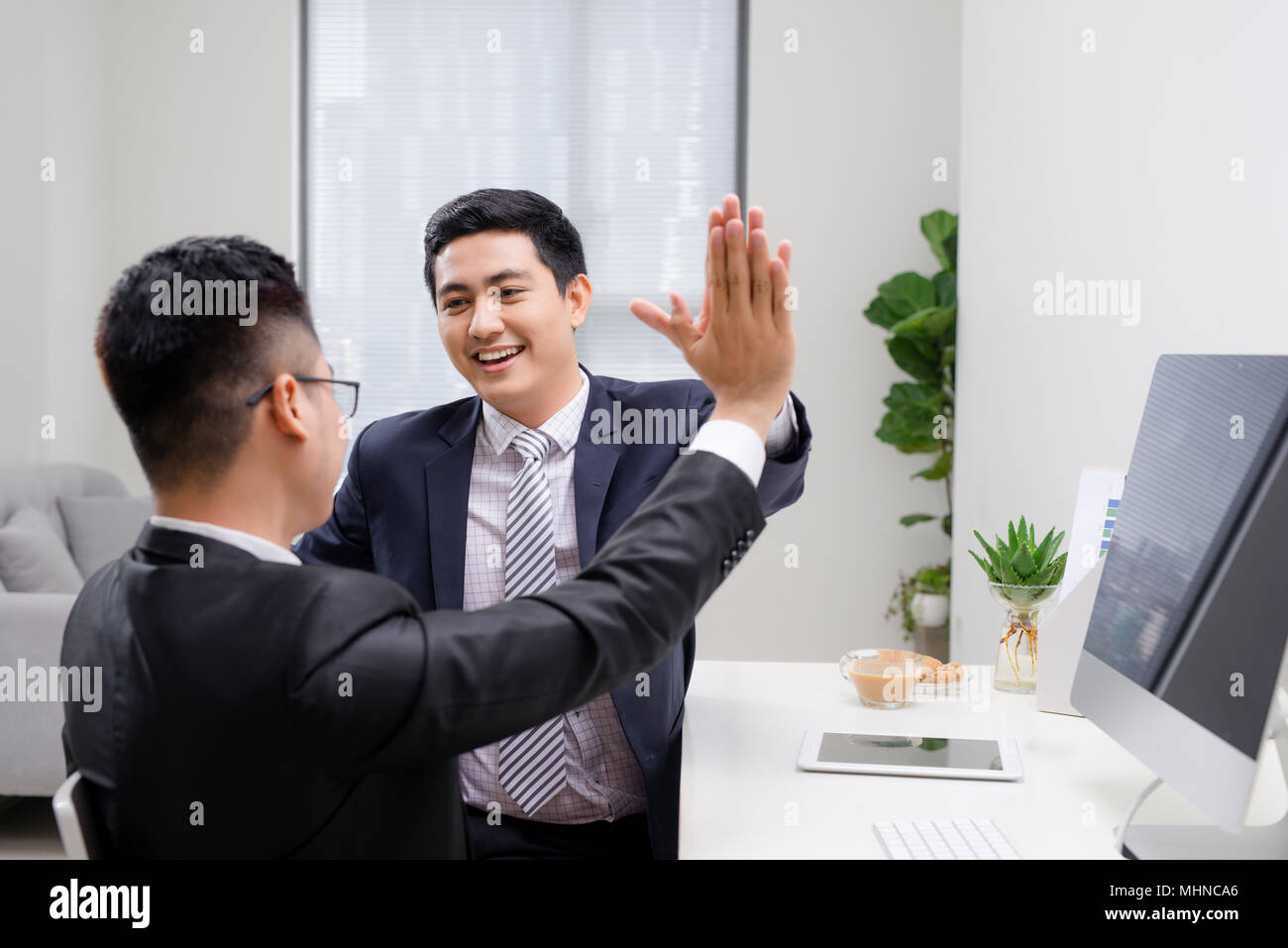 Deux hommes d'Arm wrestling concurrentes in office Banque D'Images