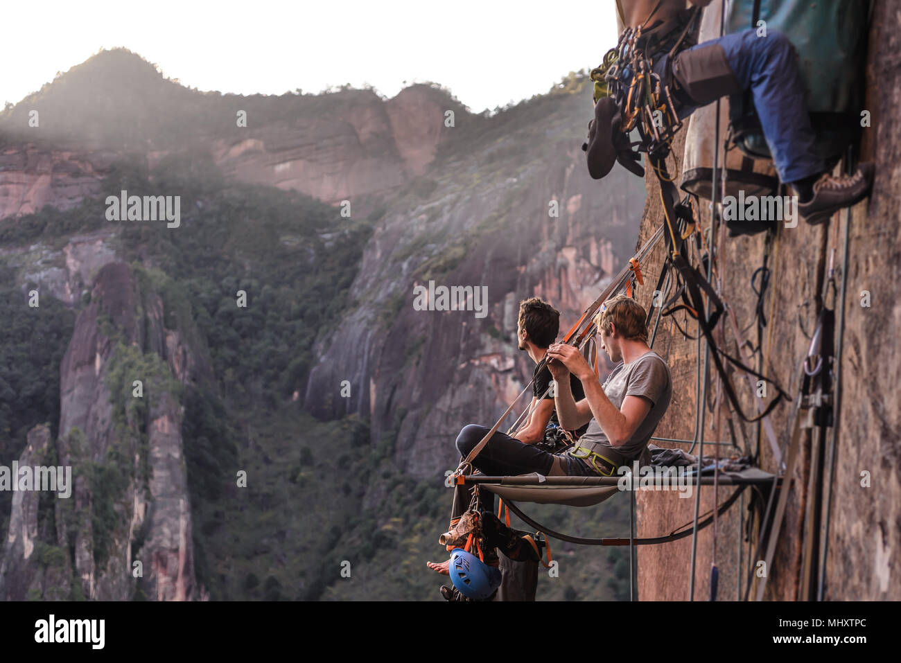 Deux grimpeurs assis sur portaledge, looking at view, le chaulage, Province du Yunnan, Chine Banque D'Images
