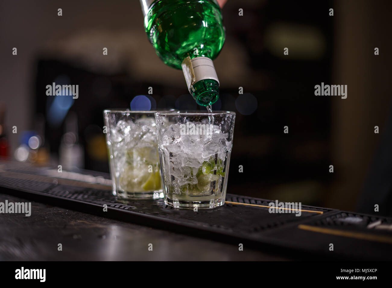 La préparation de barman mojito cocktail ; Verser le rhum Banque D'Images