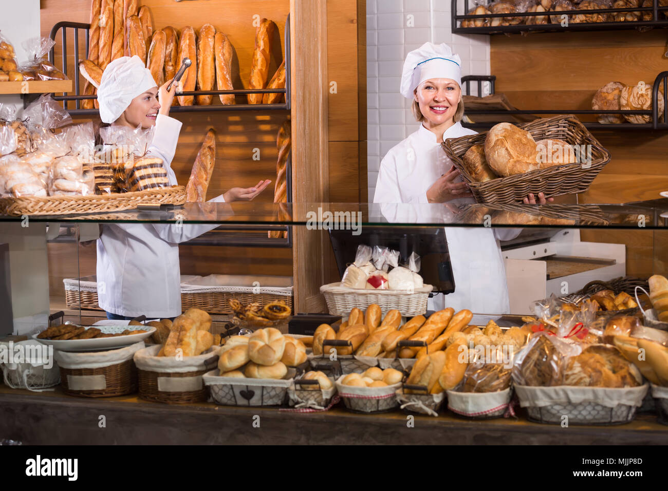 Smiling women vente boulangerie pâtisserie pains frais et du pain dans l' article Photo Stock - Alamy
