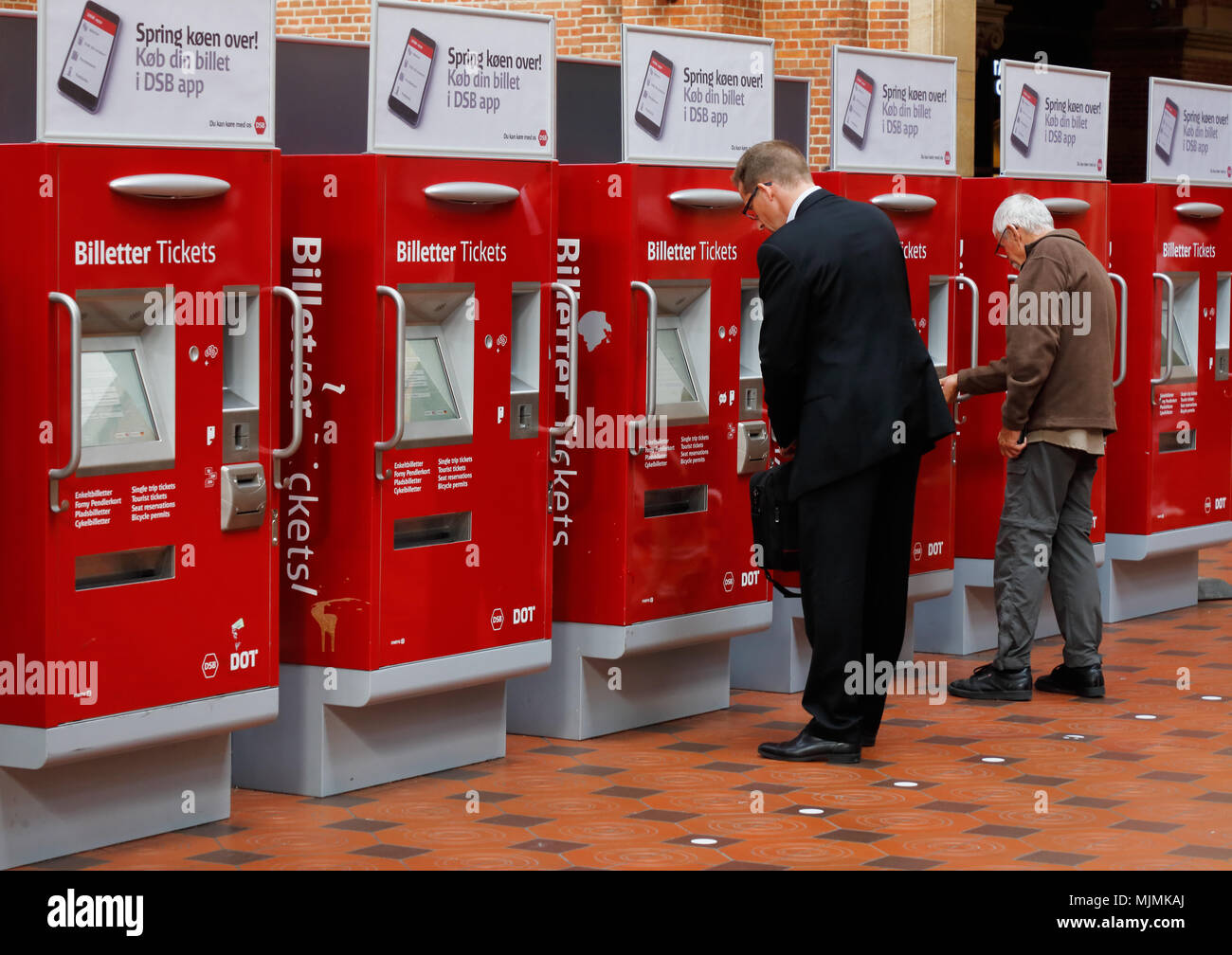 Copenhague, Danemark - 24 août 2017 : deux hommes acheter des billets à partir de distributeurs automatiques à la gare centrale de Copenhague. Banque D'Images