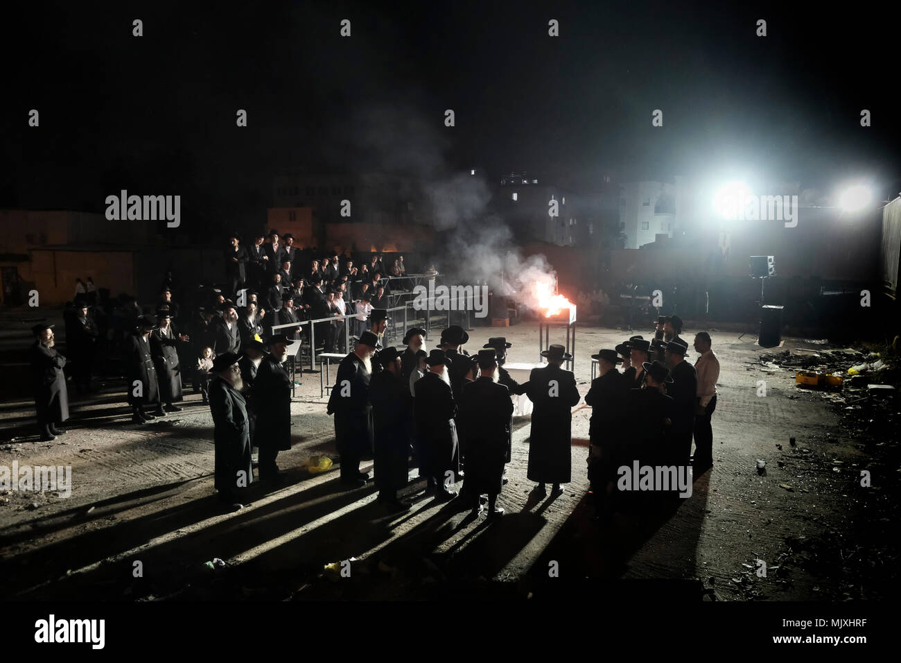 Les hommes juifs ultra-orthodoxes de la dynastie hassidique Shomrei Emounim danse comme ils allument un feu d'huile géant dans le quartier religieux Geula lors de la fête de Lag BaOmer qui marque la célébration, interprétée par certains comme l'anniversaire de la mort de Rabbi Shimon Bar Yochai, un des grands sages du judaïsme, il y a quelque 1800 ans et le jour où il a révélé les secrets de la kabbale un texte historique de la mystique juive Banque D'Images