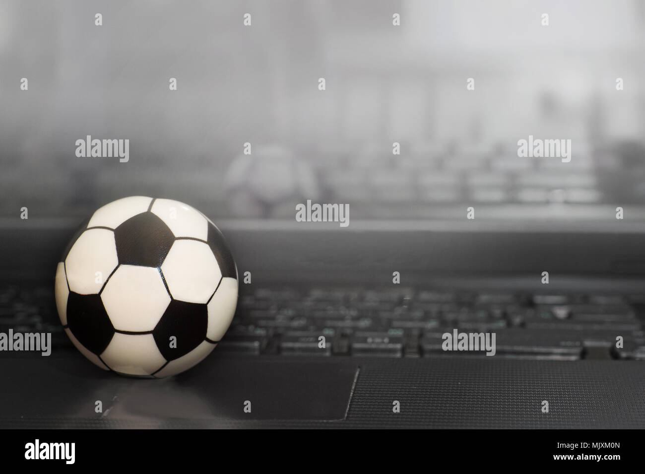 Ballon de soccer en souvenir du clavier de l'ordinateur portable. Le concept d'un match de football. Banque D'Images