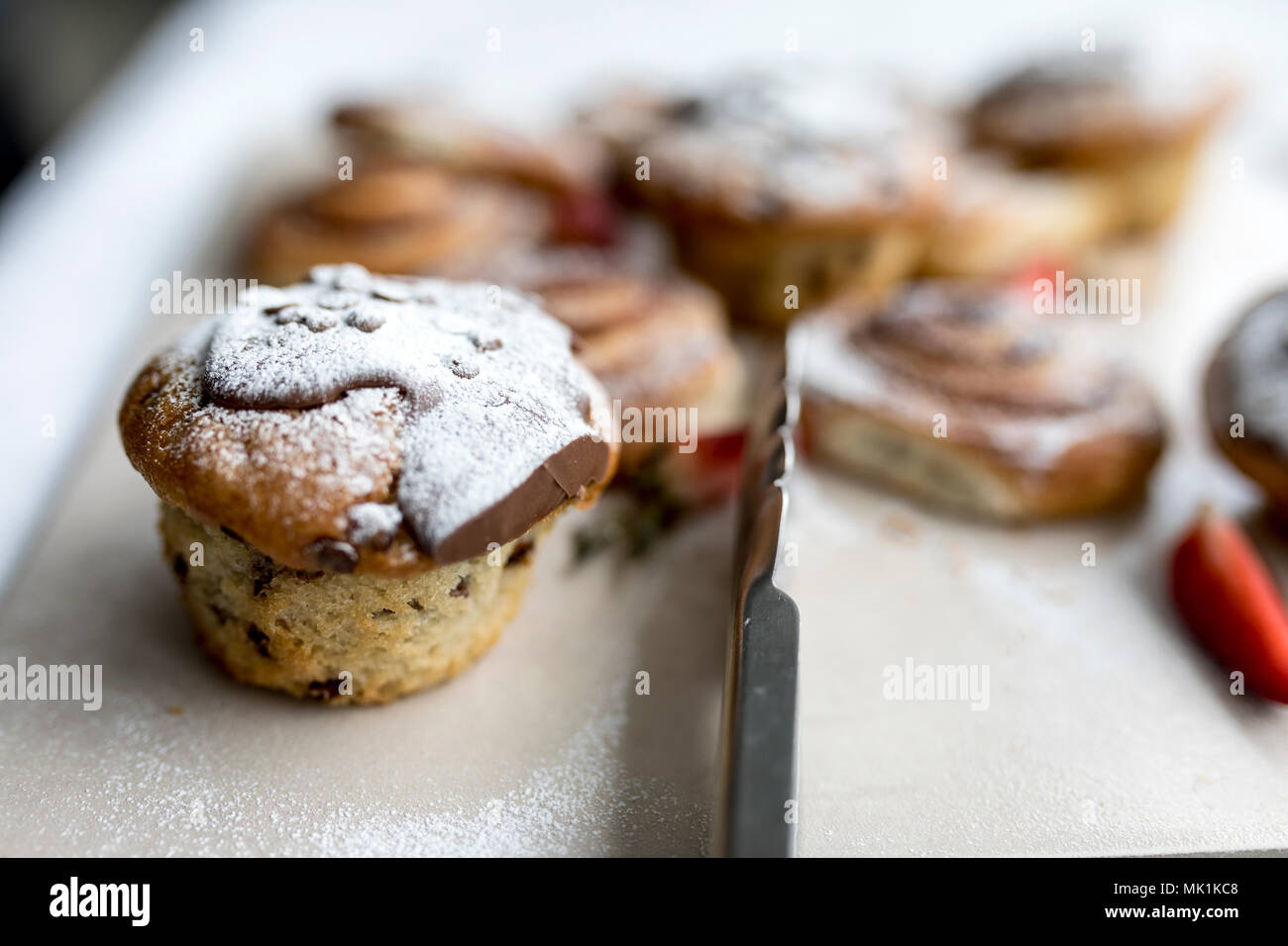 Un délicieux, des pépites de chocolat chocolat muffins en gelées ou spinkled de sucre glace sur un buffet de petit-déjeuner d'affaires au Royaume-Uni Banque D'Images