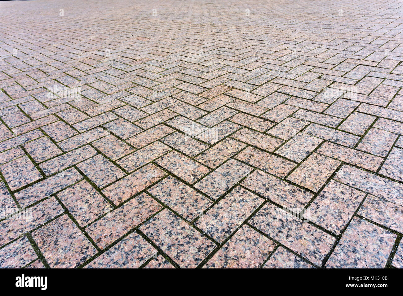 Contexte - une zone pavée de dalles de pavage en granit, s'étendant en perspective Banque D'Images