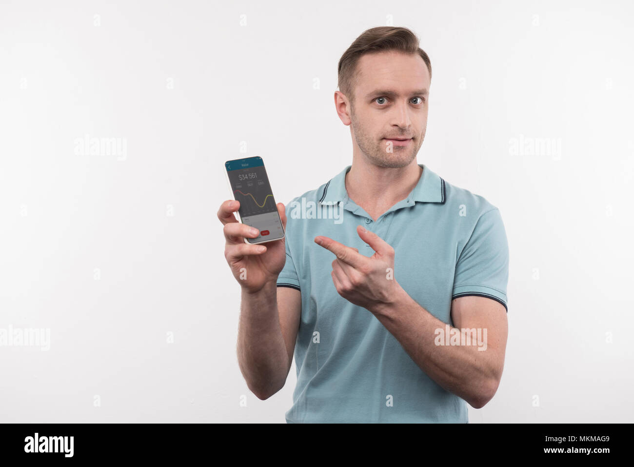 Bel homme sérieux montrant son téléphone Banque D'Images