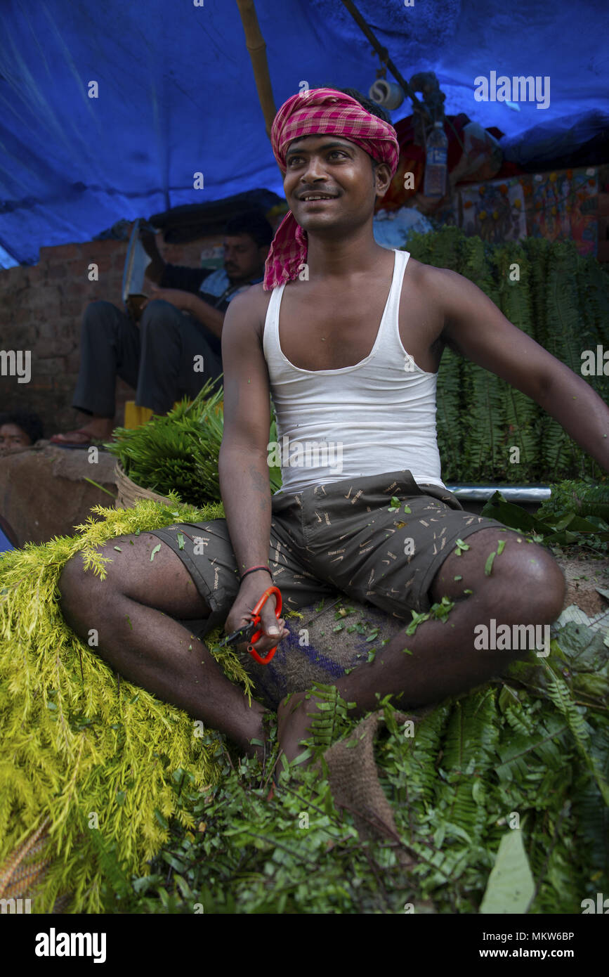 Vendeur de fleurs au Malik Ghat Marché aux fleurs à Kolkata, Inde Banque D'Images