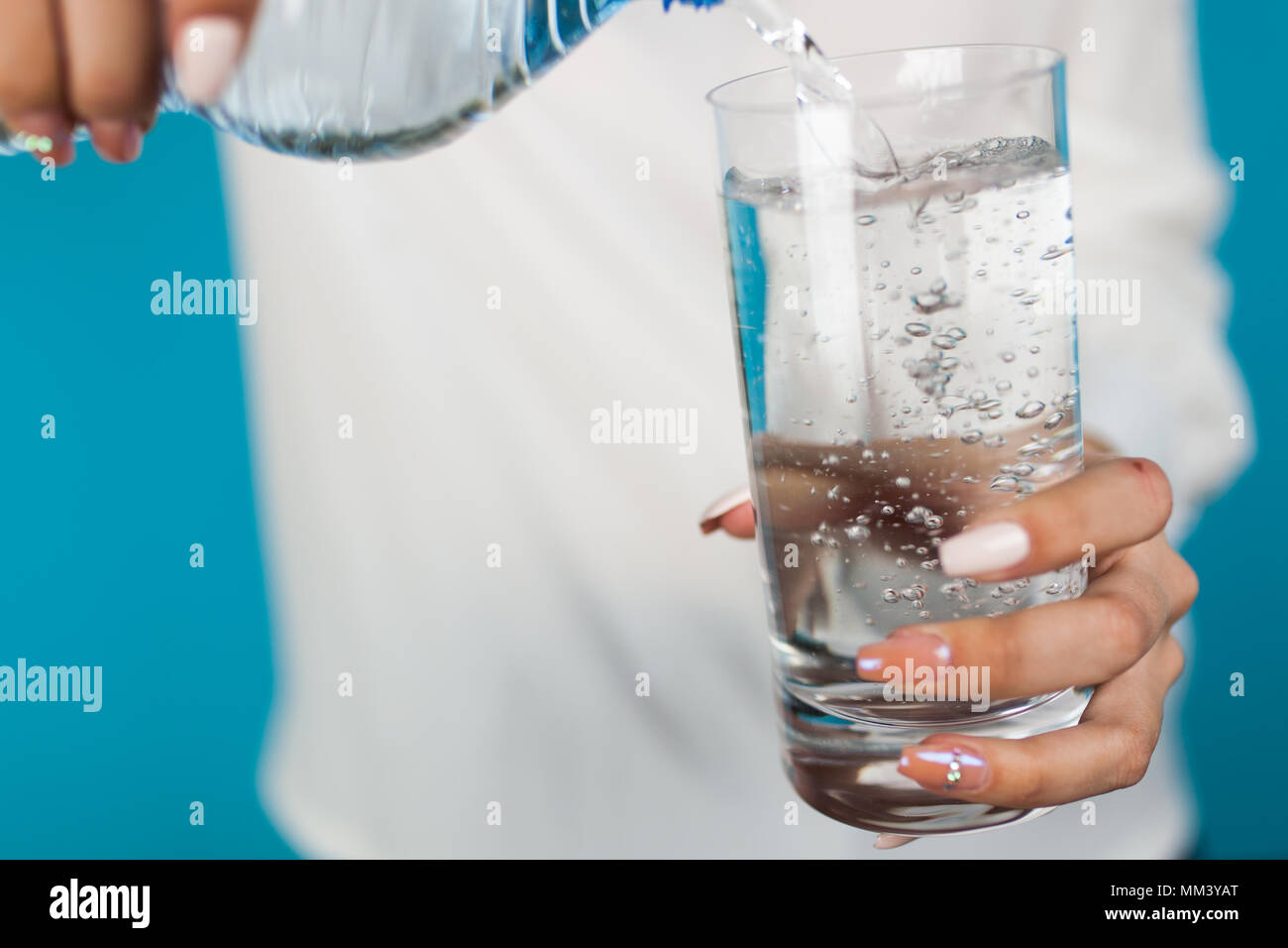 Femme de remplir un verre d'eau Banque D'Images