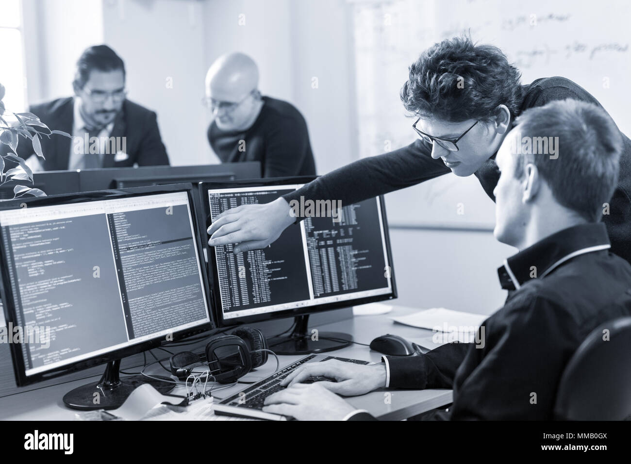 L'entrepreneuriat et démarrage d'entreprise la résolution de problèmes. Les jeunes programmeurs IA et il les développeurs de logiciels de programmation et de réflexion de l'équipe sur le bureau c Banque D'Images
