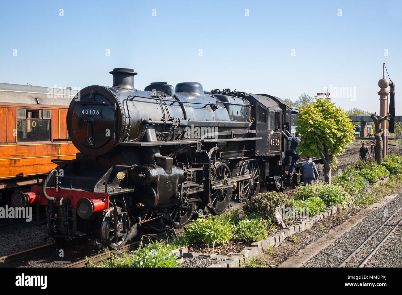Ancienne locomotive à vapeur britannique dans les sidings, gare de Severn Valley Kidderminster, alors que l'équipage du train à vapeur, les travailleurs ferroviaires préparent une grue d'eau. Banque D'Images