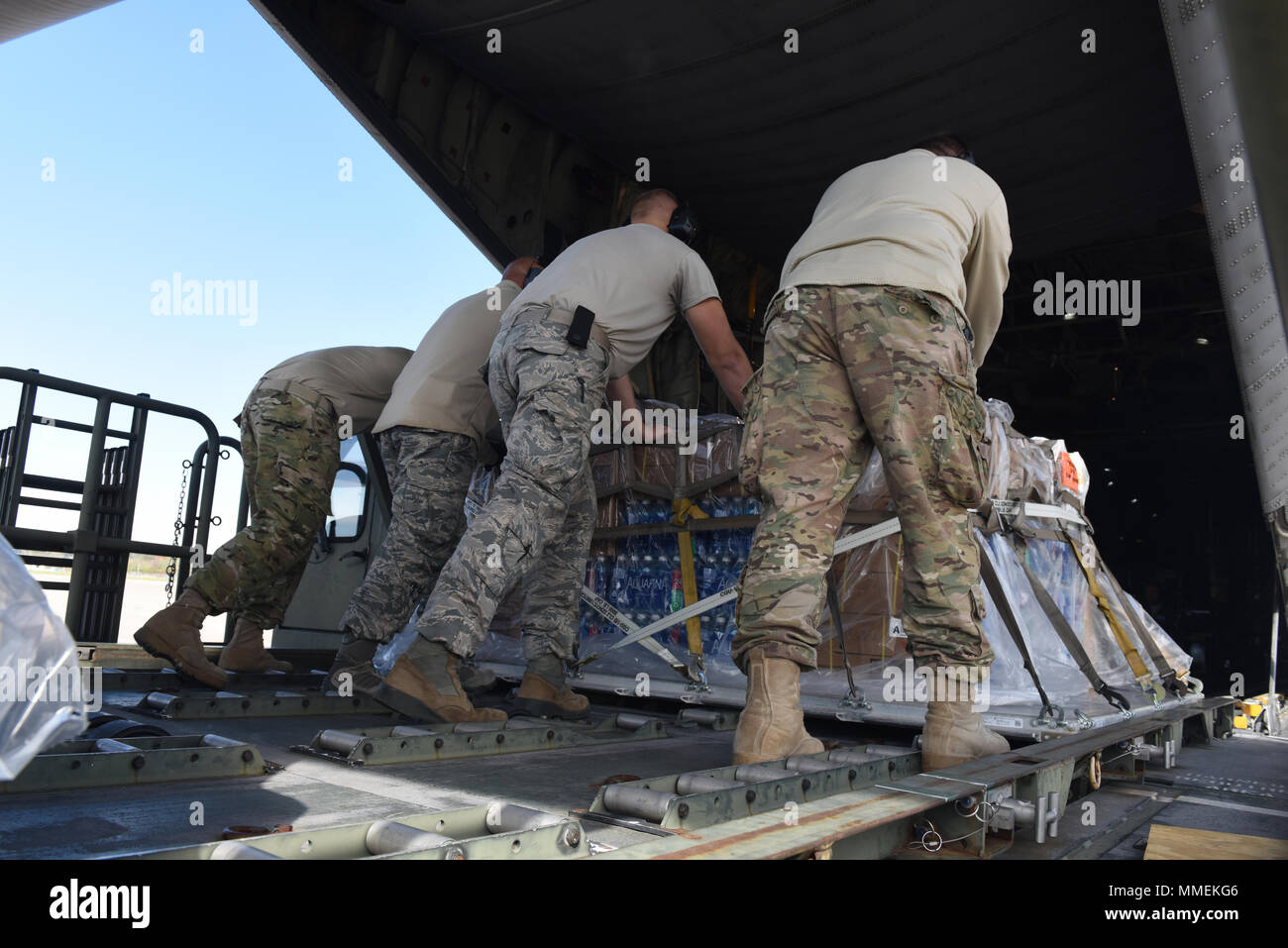 Aviateurs de la 193e Escadre d'opérations spéciales de l'antenne du Port, Middletown, Connecticut, charger des cargaisons sur une CL-130H Hercules, à partir de la 109e Escadre de transport aérien, Schenectady, New York, 25 octobre 2017. L'aéronef est utilisé pour envoyer les 201e Escadron Cheval Rouge aviateurs à Sainte-Croix, les Îles Vierges des États-Unis à l'appui de l'Ouragan Maria's relief et les efforts de reconstruction. Ils vont maintenir les tentes et les divers équipements utilisés dans l'aide en cas de catastrophe dans le lit pour système de répondeur. (U.S. Air National Guard photo par le Sgt. Matt Schwartz/libérés) Banque D'Images
