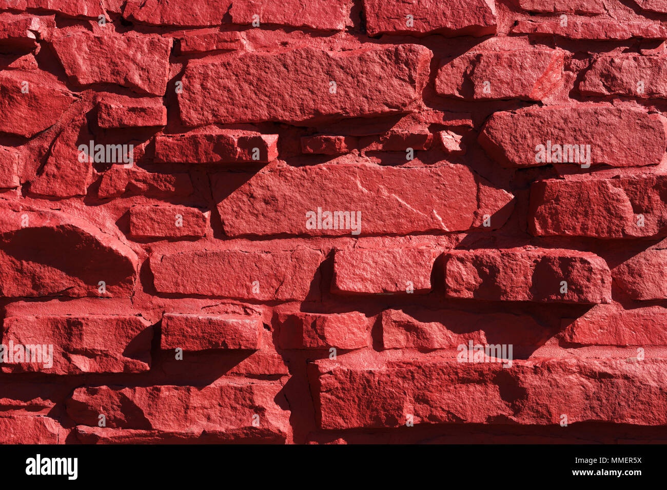 Gros plan de l'extérieur mur de pierre d'un bâtiment peint en rouge. Banque D'Images