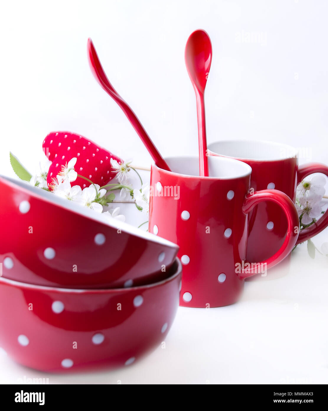 Blue polka dot bols, tasses et cuillères sur un fond blanc Banque D'Images