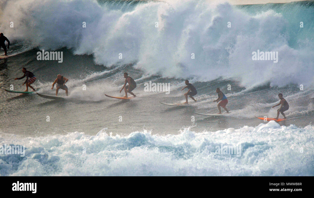 Surfers profitez d'un trajet de l'onde à Waimea Bay, North Shore d'Oahu, Hawaii, USA Banque D'Images