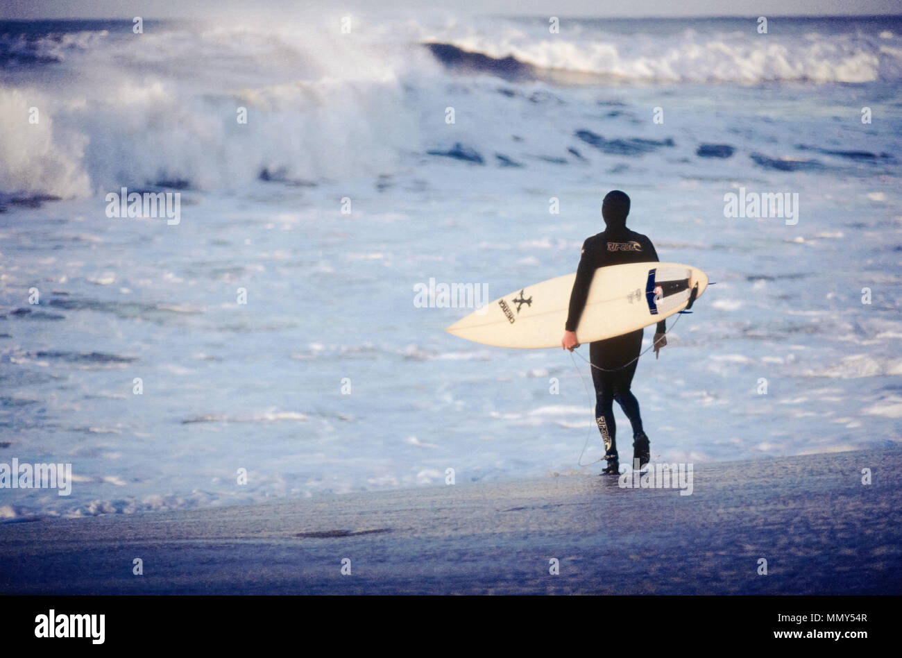 Surfeur solitaire entrant dans le surf à Bells Beach, Torquay, Surf Coast Shire, Great Ocean Road, Victoria, Australie Banque D'Images