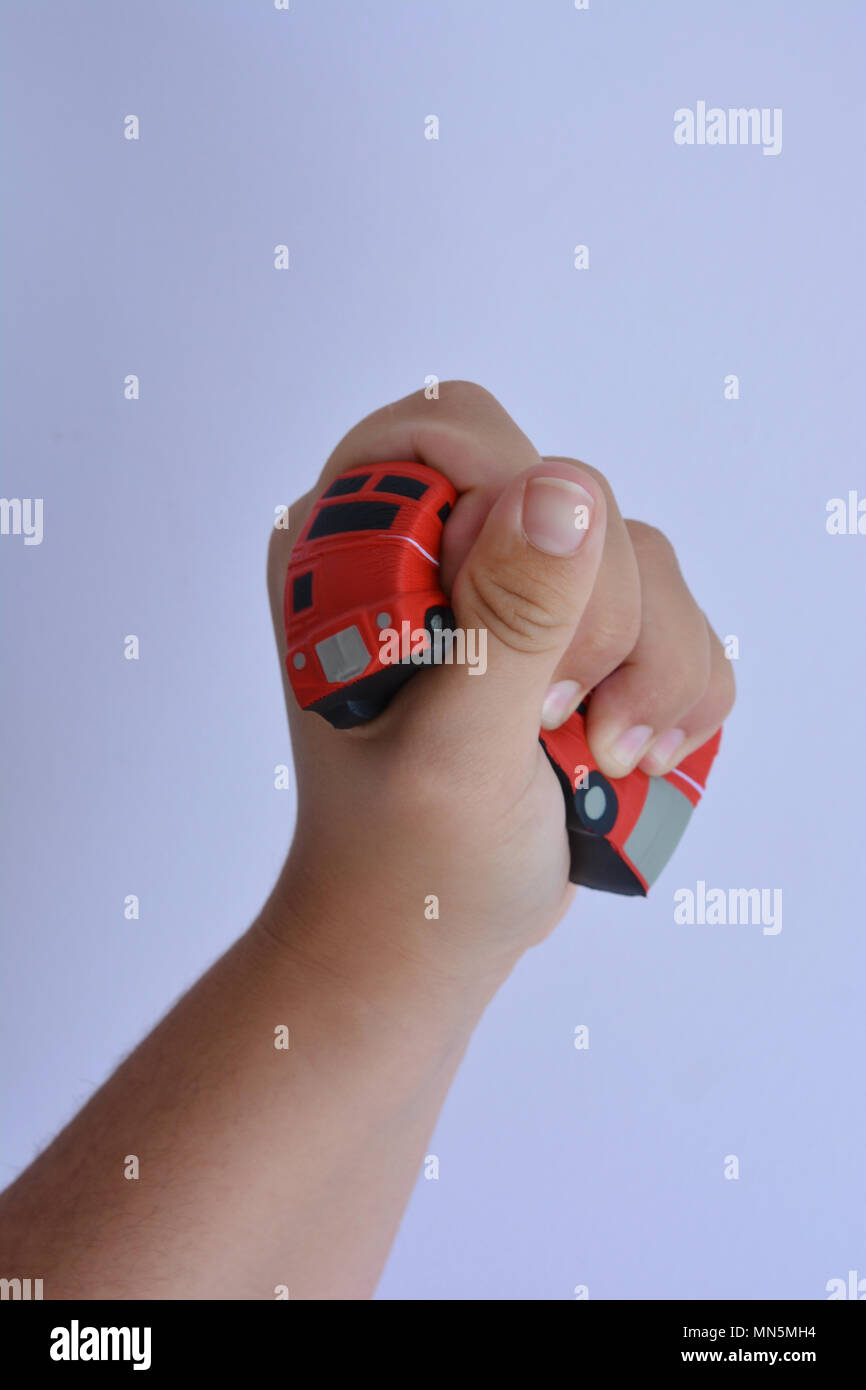 Woman squeezing red bus stress en forme, Close up contre un fond uni avec copie espace. Banque D'Images