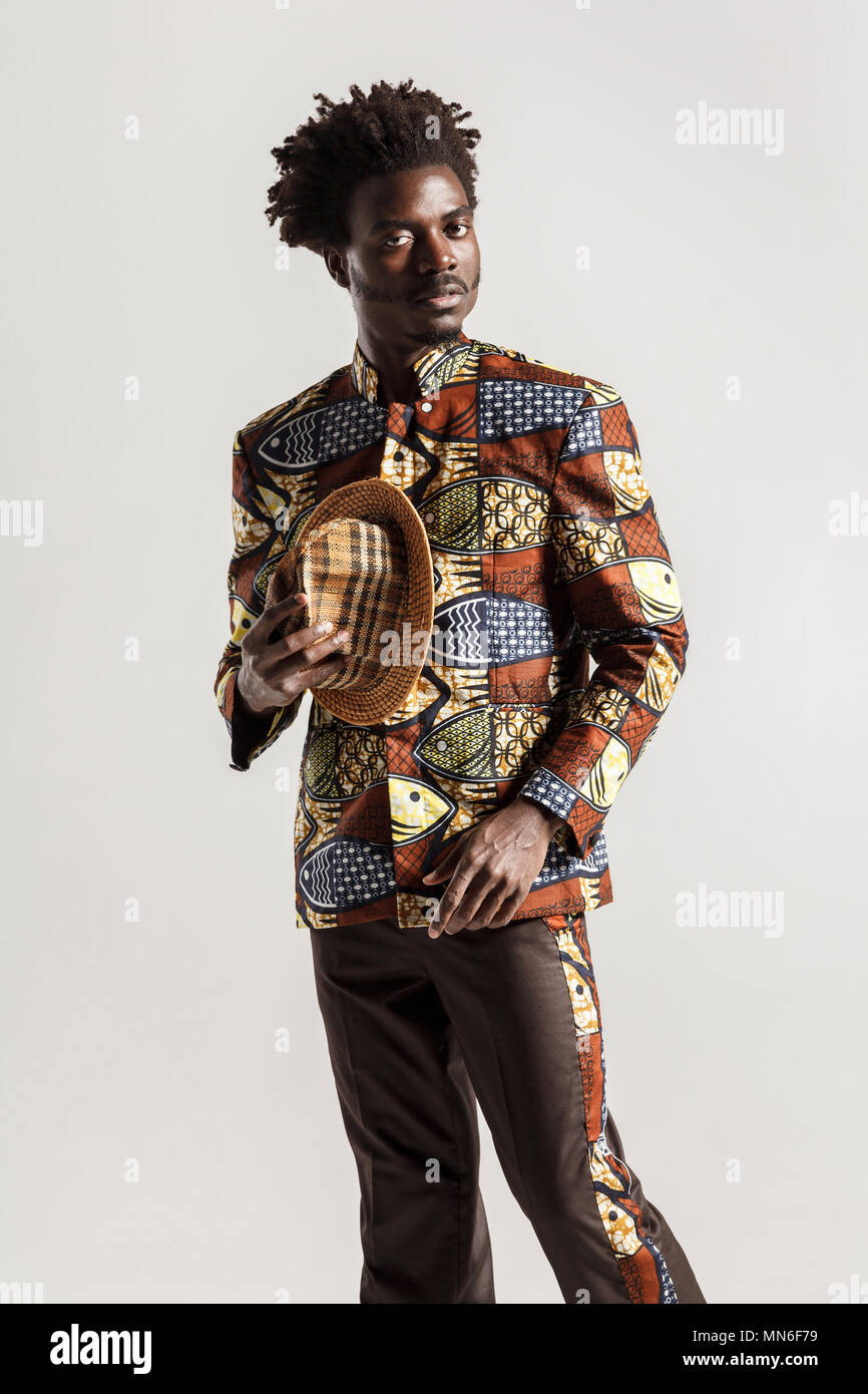Richement et luxe homme africain en vêtements traditionnels. Piscine, isolé sur fond gris Banque D'Images
