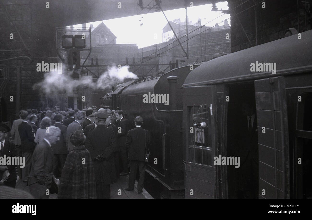 Années 1960, photo historique montrant un groupe de personnes en attente par une locomotive à vapeur à l'extérieur sur une plate-forme au centre de Liverpool, la gare de Lime Street, England UK.. Banque D'Images