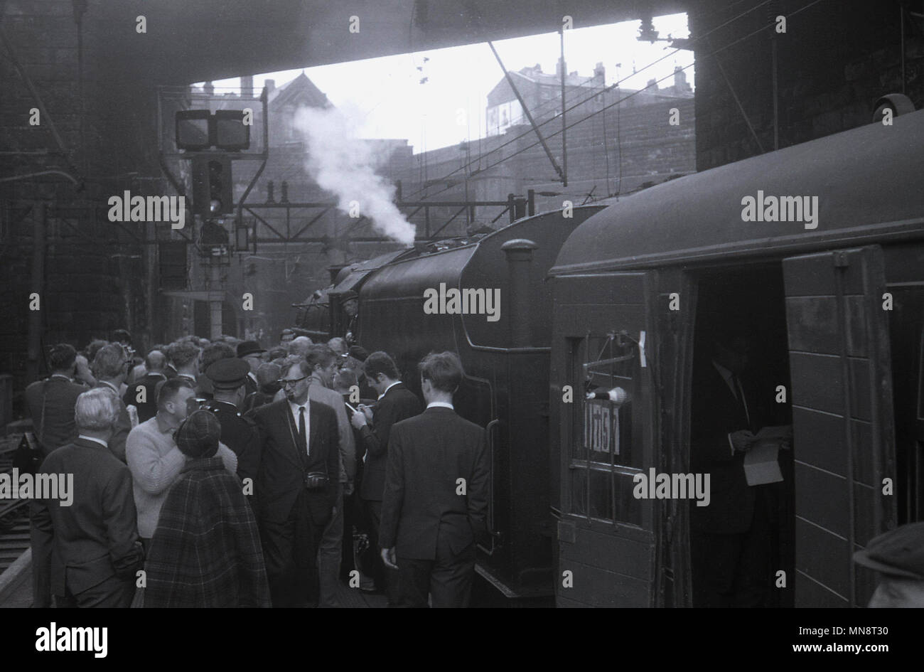 Années 1960, photo historique montrant un groupe de personnes en attente par une locomotive à vapeur à l'extérieur sur une plate-forme au centre de Liverpool, la gare de Lime Street, England UK.. Banque D'Images