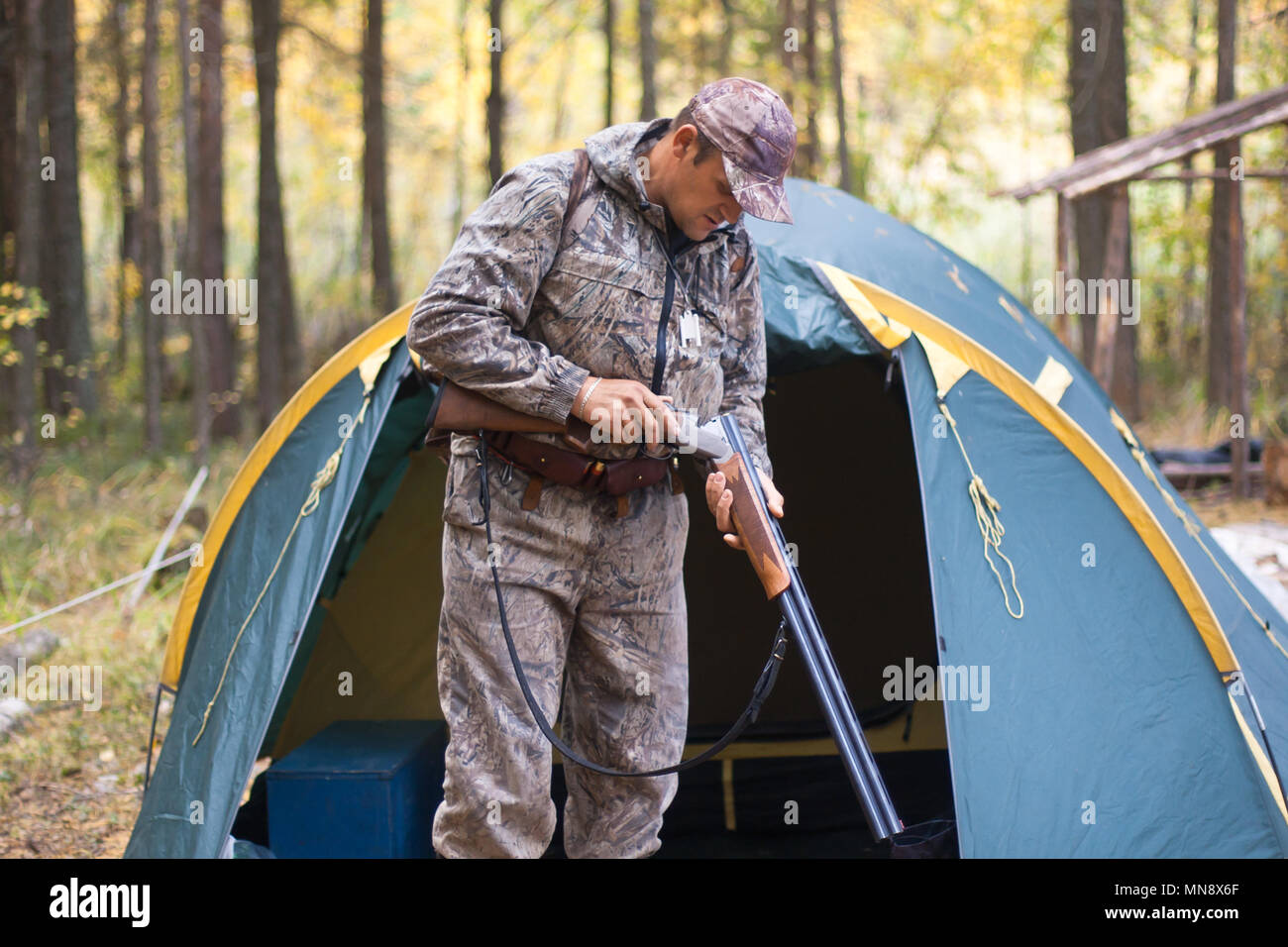 Charge son fusil de chasse avant de la chasse dans le camp de chasse Banque D'Images