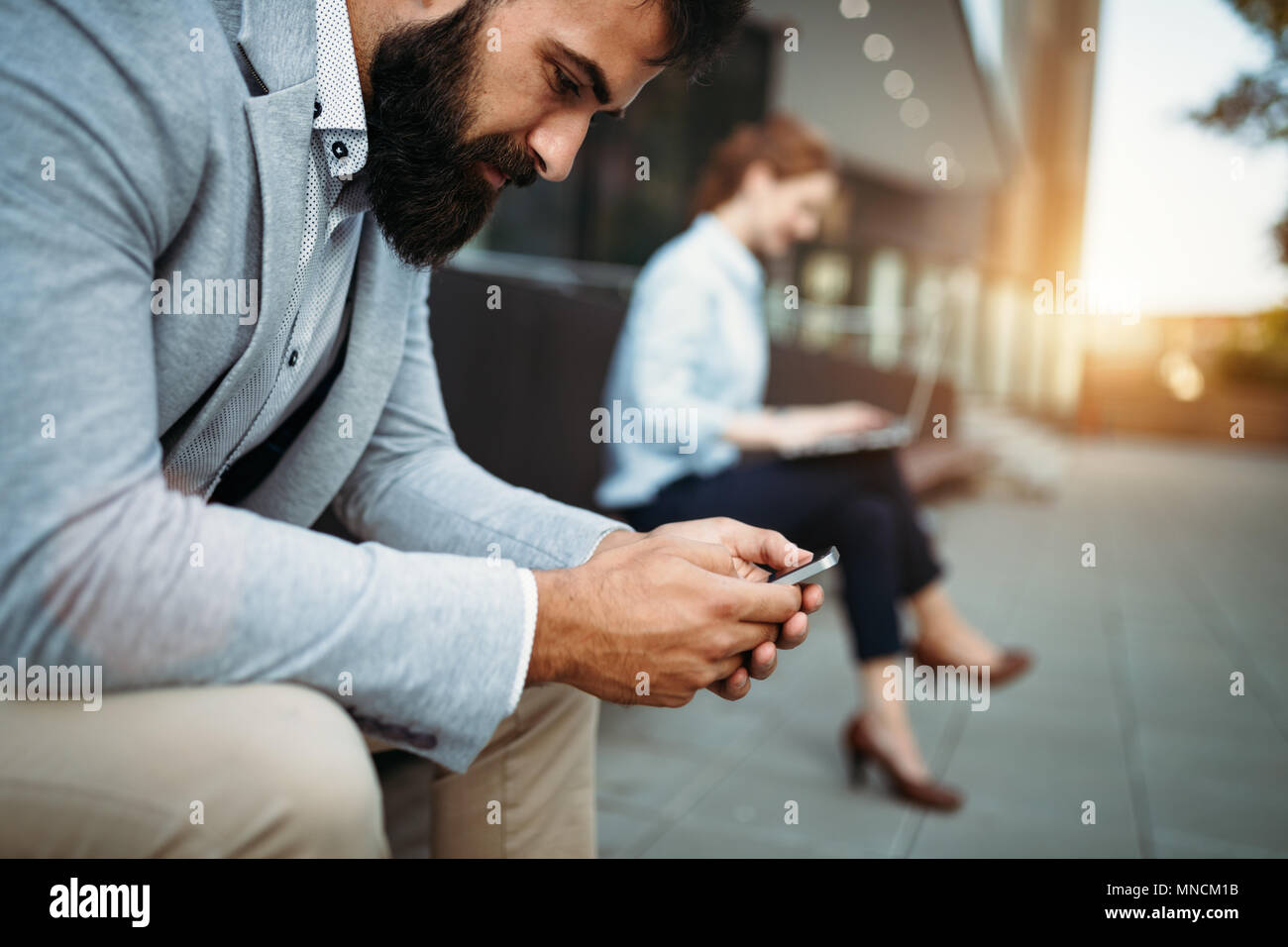 Shot of businessman sitting on bench with digital tablet Banque D'Images