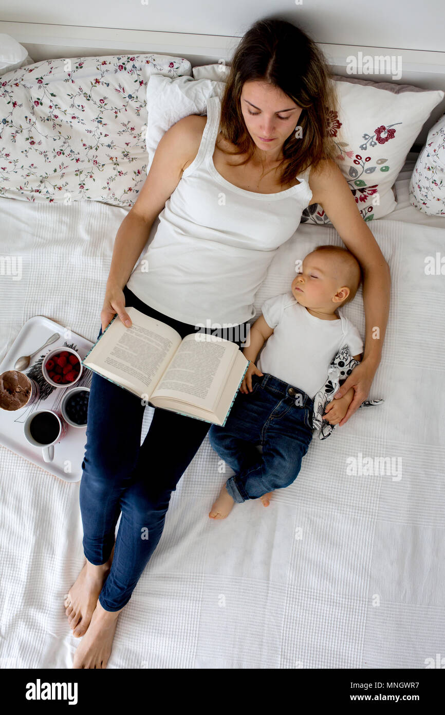 Mere Et Enfant Bebe Garcon Au Lit Maman Bebe Dormir Lire Un Livre Et Manger Des Fruits Et De La Creme Glacee High Angle Shot D En Haut Heureux Famil Photo Stock Mere Et Enfant Bebe Garcon Au Lit Maman Bebe Dormir Lire Un Livre Et Manger Des Fruits Et De La Creme Glacee High Angle Shot D En Haut Heureux Famil Photo Stock