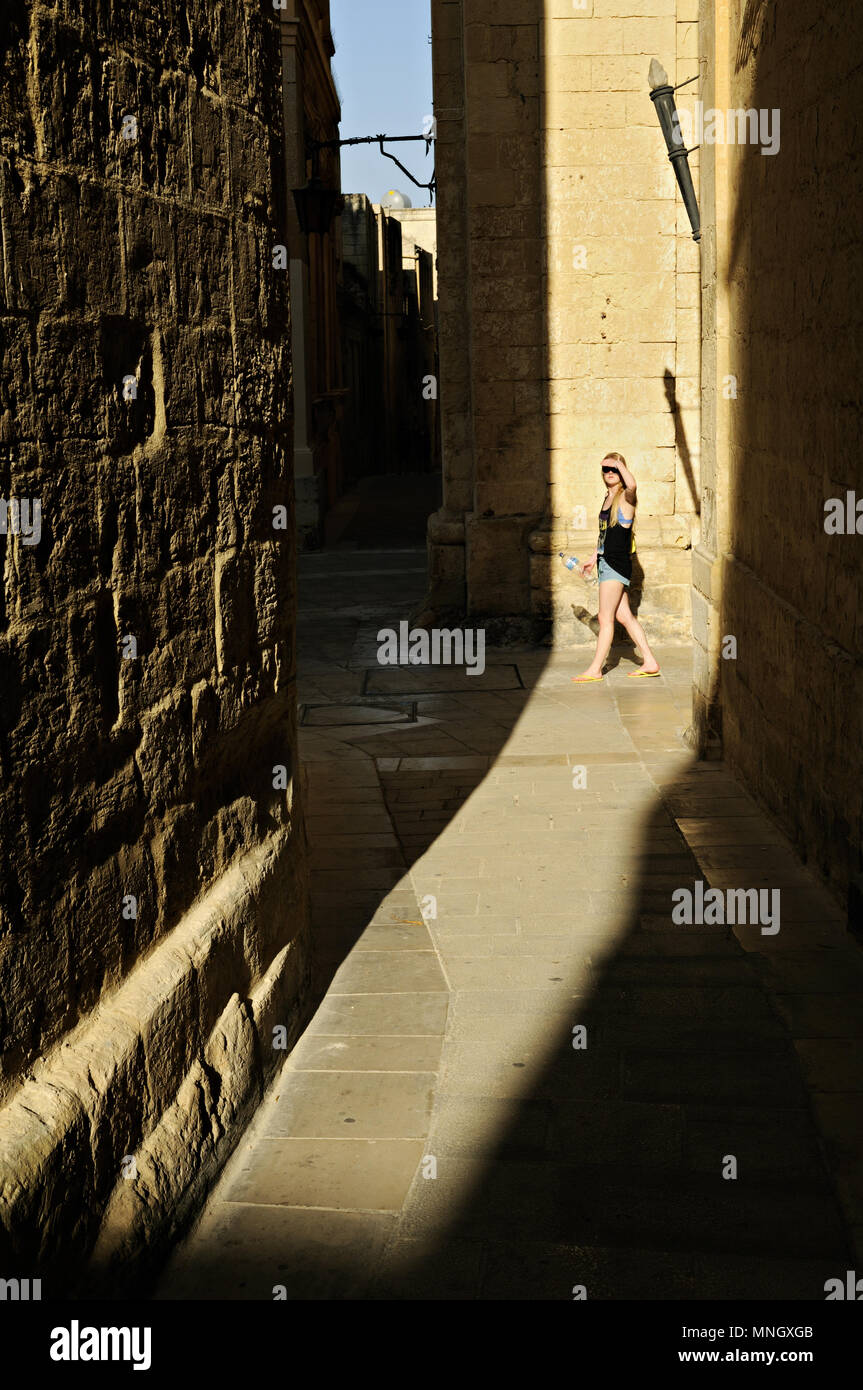 Jeune femme marche dans la vieille ville de Mdina, Malte Banque D'Images