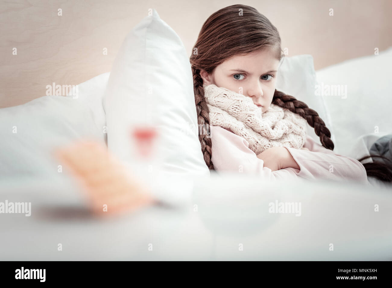 Femme brunette sérieuse à la médecine à son Banque D'Images