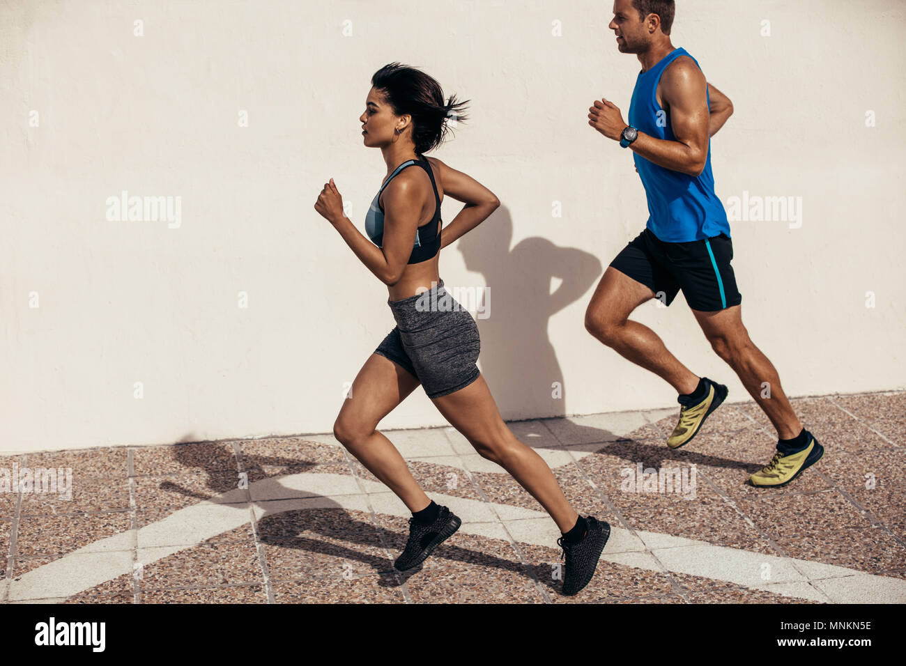 Deux coureurs d'exécution à l'extérieur en matinée. L'homme et la femme marcher ensemble. Banque D'Images