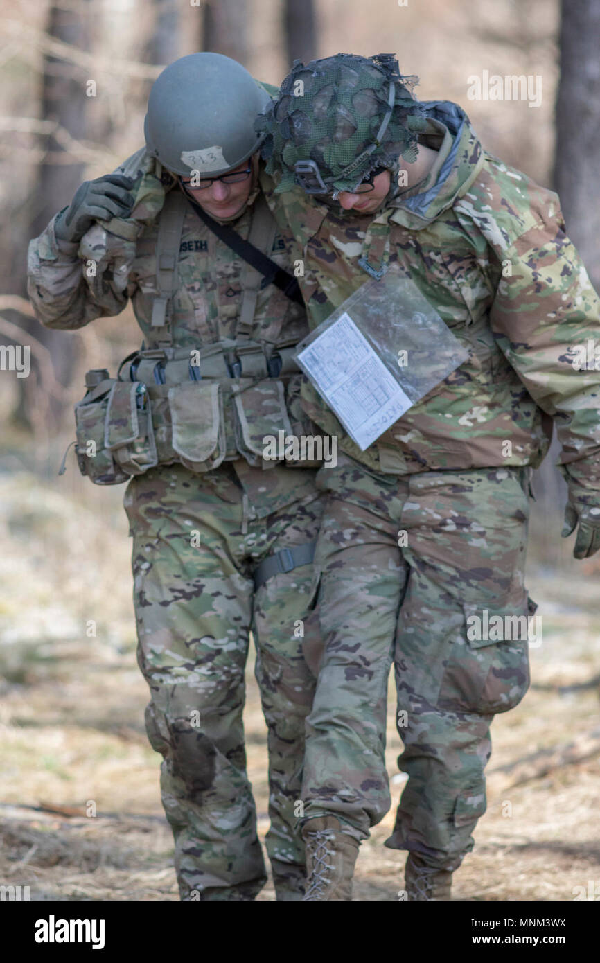 Grafenwoehr, Allemagne - PFC. Peyton, Dunseth combattre medic, 173ème Infantry Brigade Combat Team (Airborne), aide un blessé pour une litière improvisée au cours de l'armée américaine l'Europe Printemps 2018 Badge sur le terrain par les experts de l'événement médical le 19 mars 2018. Banque D'Images