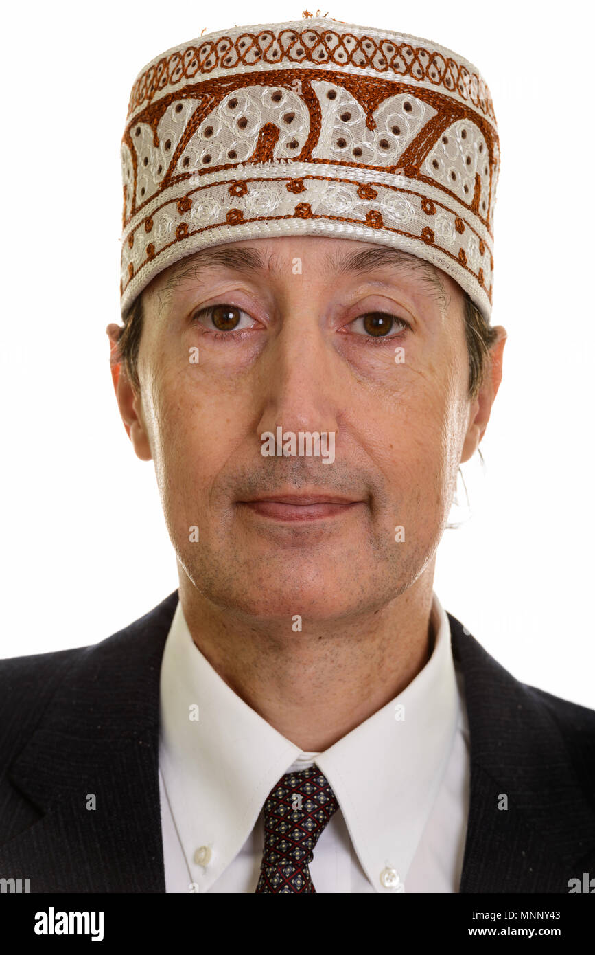 Visage de mature businessman wearing hat ethnique traditionnel Banque D'Images
