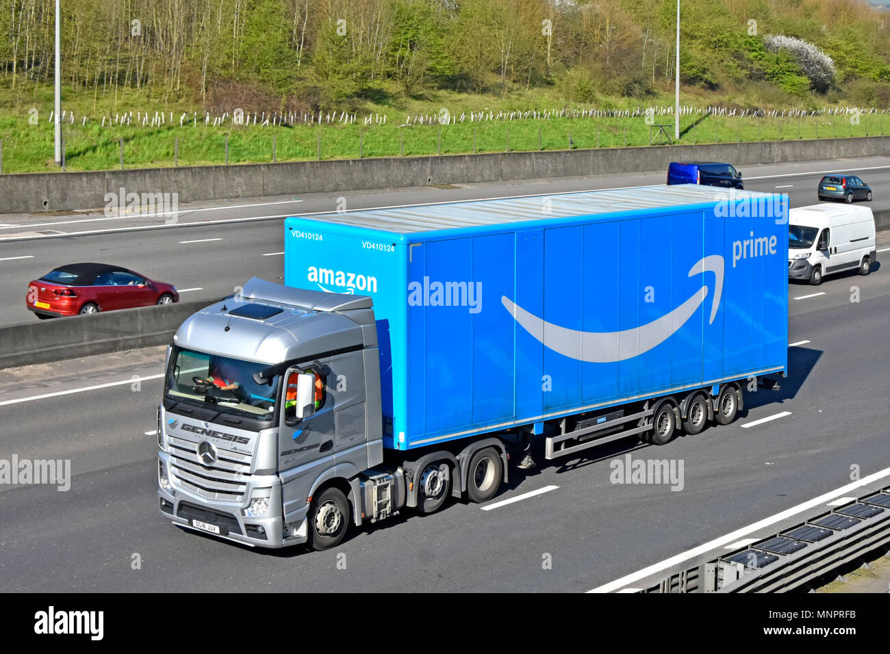 Du côté de l'avant et à la logistique des transports poids lourds Mercedes camion Truck & Trailer articulé bleu marque publicité Amazon Prime Service & logo sur autoroute britannique Banque D'Images