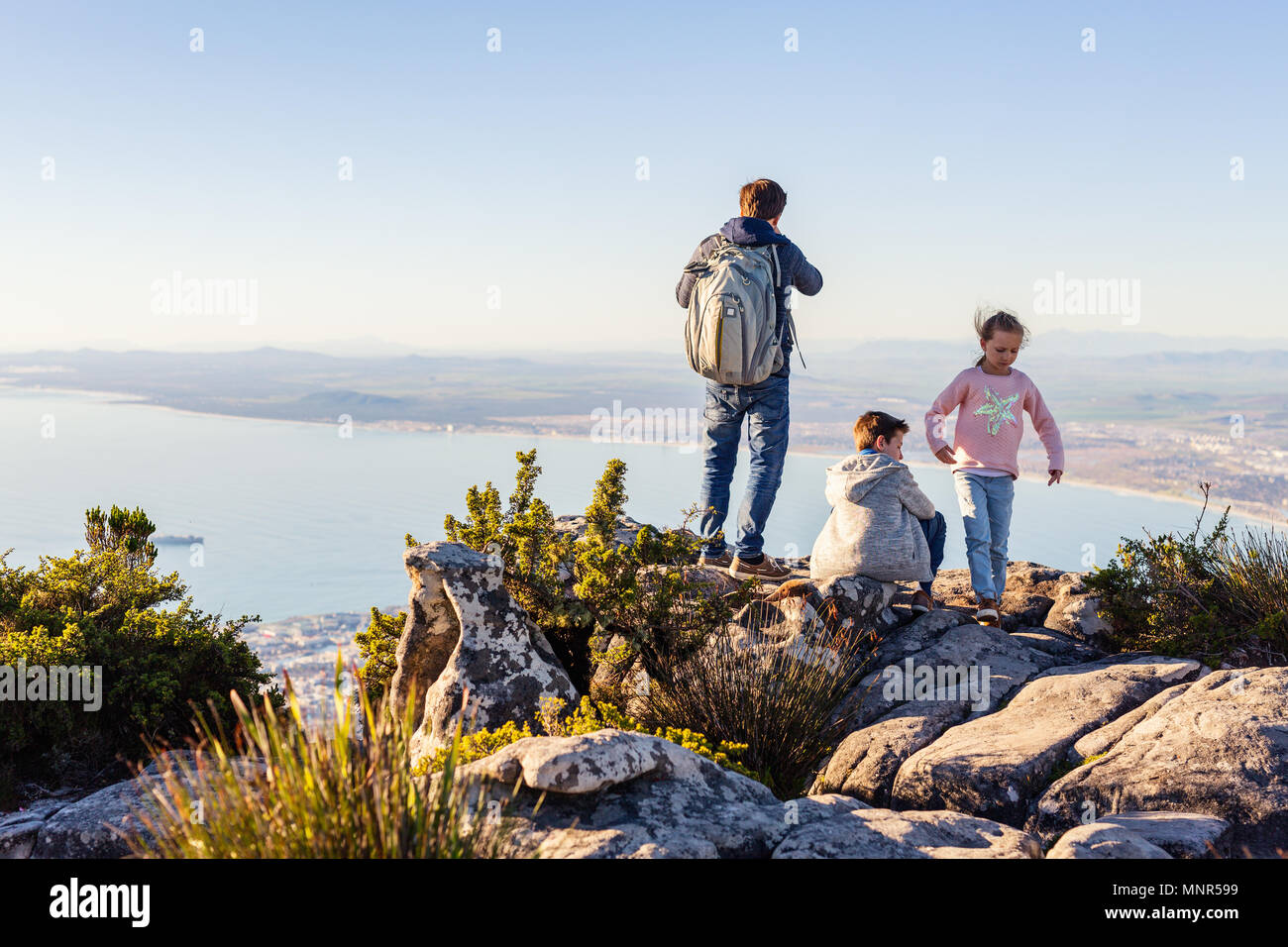 Famille du père et de deux enfants bénéficiant d'une vue imprenable sur Cap du haut de la montagne de la table Banque D'Images