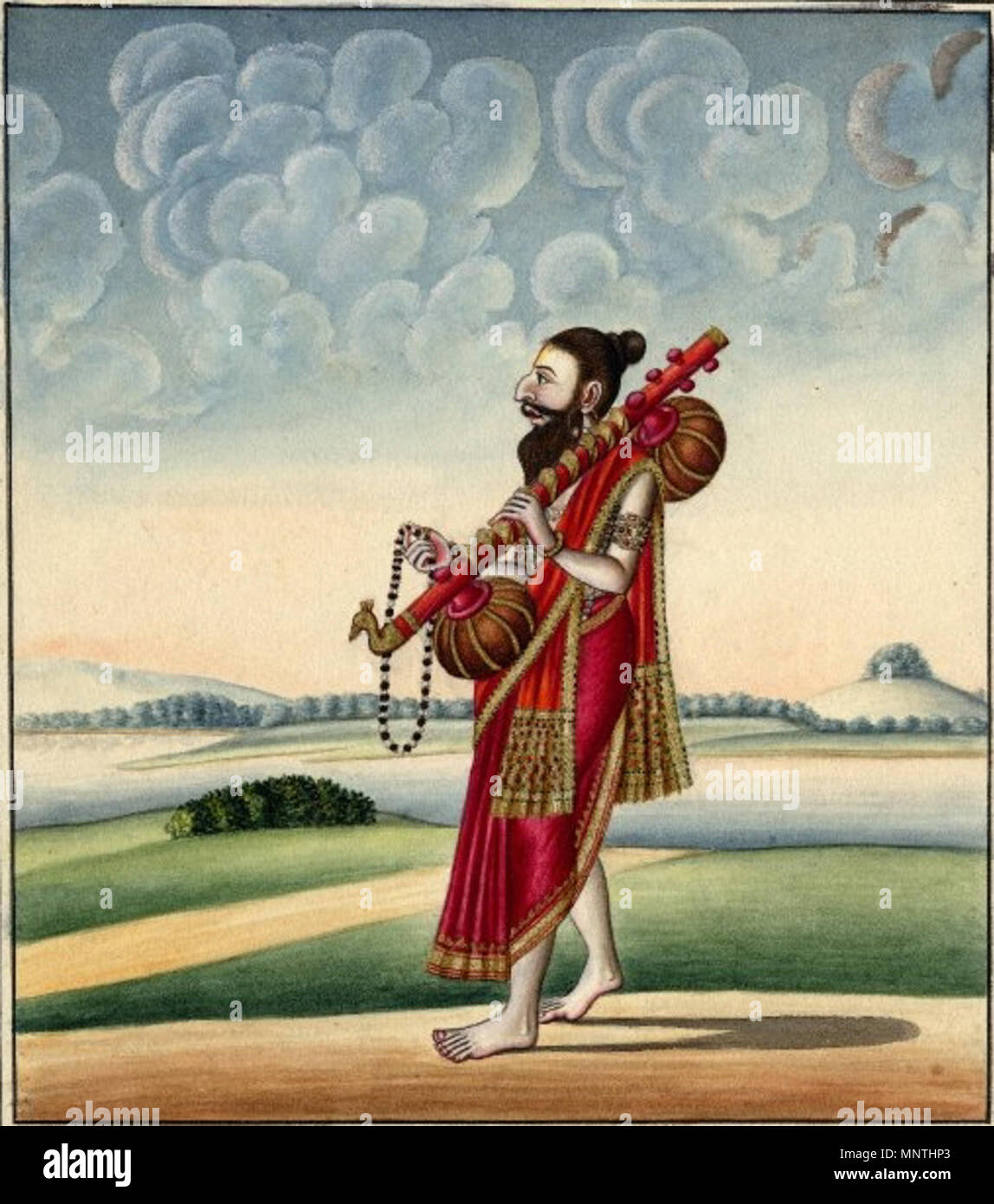 . Anglais : Aquarelle sur papier d'une figure masculine, peut-être même Narada, l'inventeur de la Vina. L'homme est montré la marche dans un paysage vallonné avec des arbres au loin. Il porte un dhoti rouge, bordé d'or avec un châle drapé sur son épaule. Ses cheveux sont attachés dans un noeud et il a une barbe complète. Il est titulaire d'un long chapelet dans sa main droite et dans sa main gauche il tient une vina qu'il repose contre son épaule. Une extrémité de la vina est orné d'un fleuron d'oiseaux. Son ombre est une boucle gris attaché à chaque pied. La peinture est entouré d'une bordure noire . 19thC(début). Com Banque D'Images