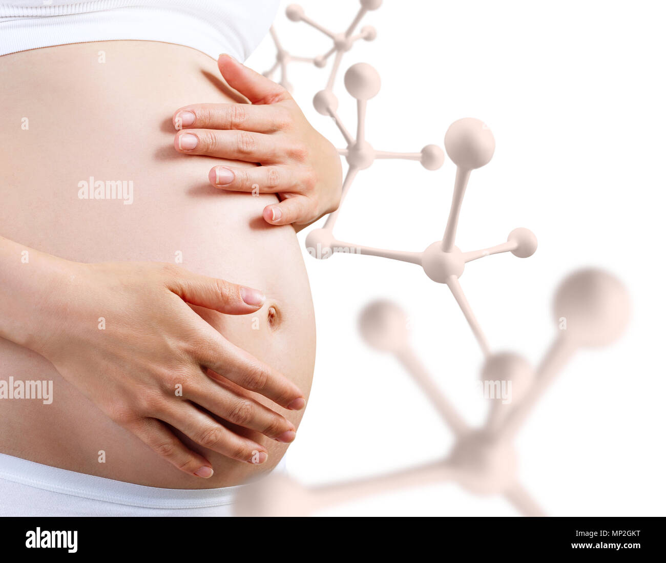 Jeune femme enceinte se caresser le ventre près de Big White molécule. Banque D'Images