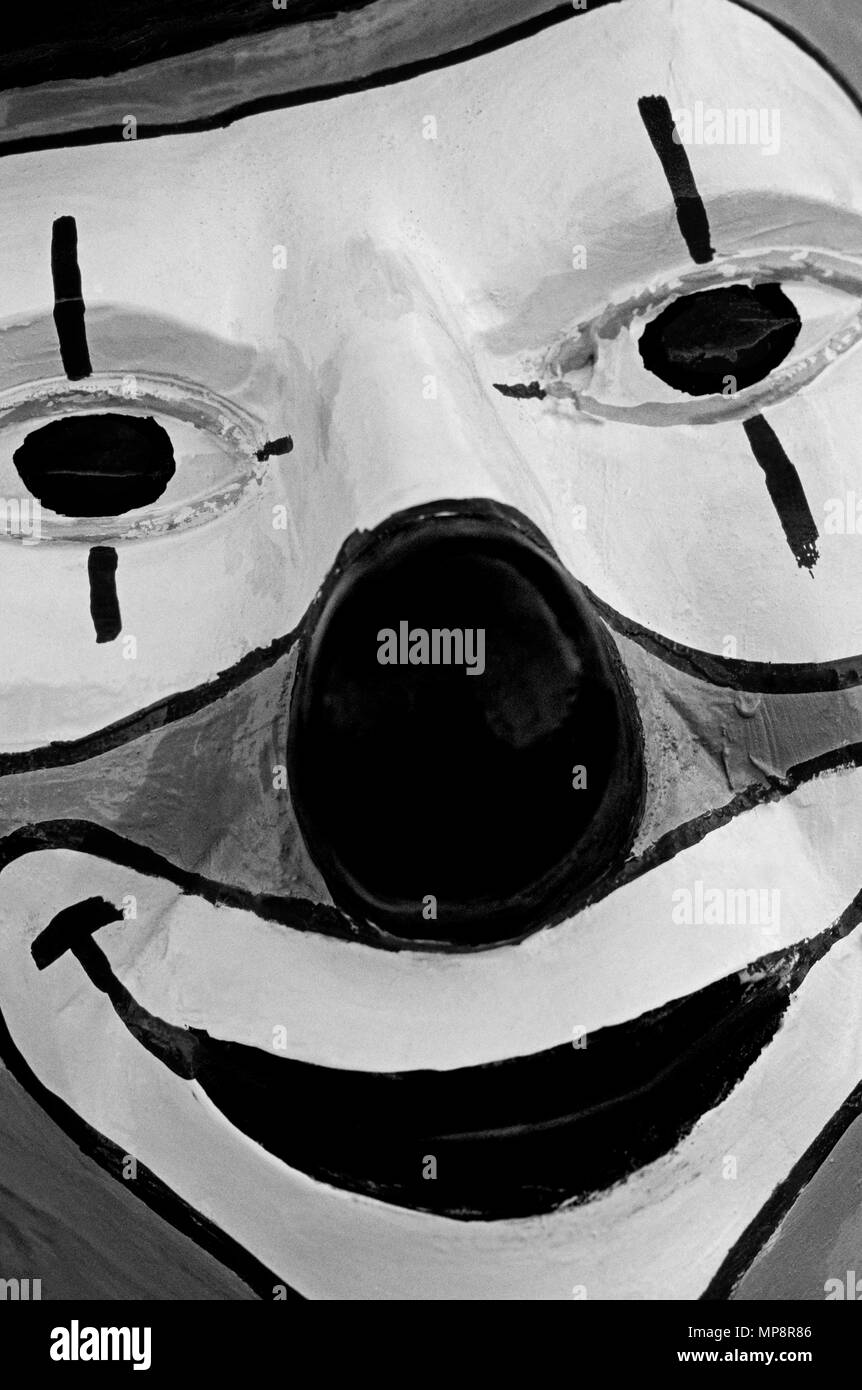 Clow face close-up sculpture sur bois avec happy clown visage et nez rouge. Banque D'Images