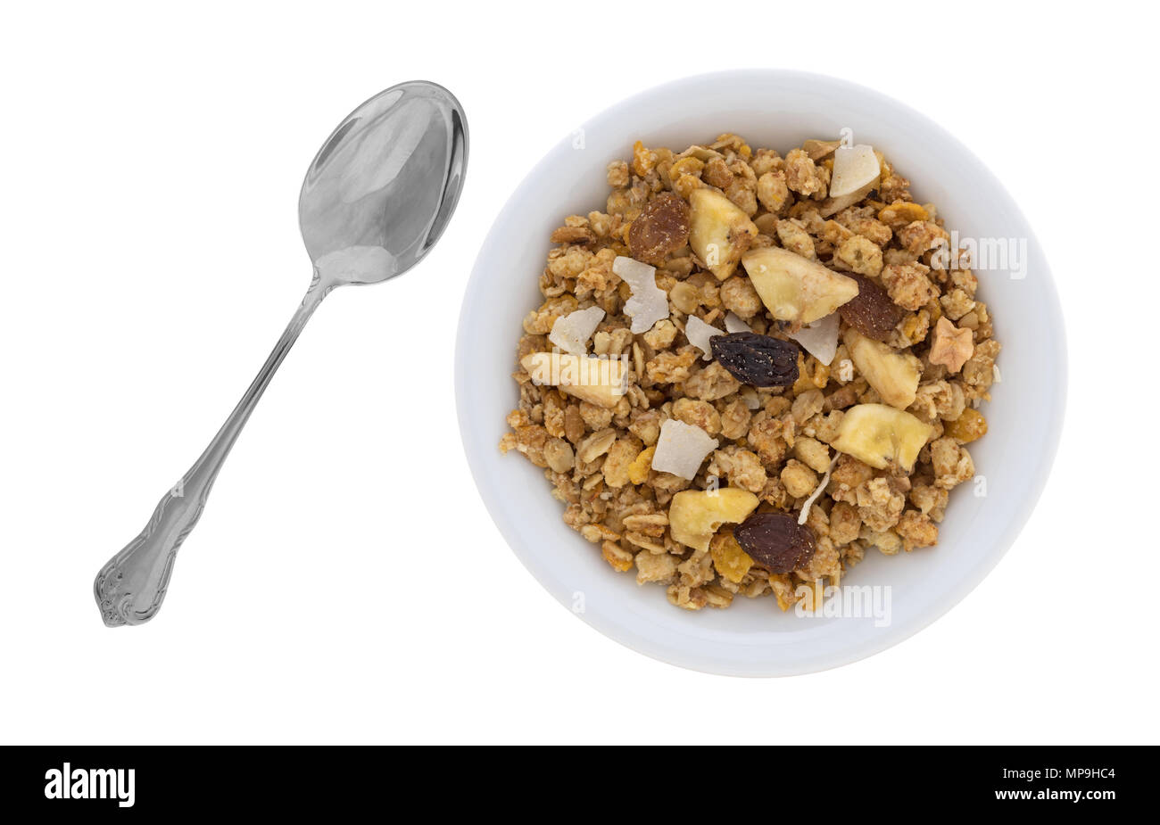 Vue de dessus du gel avec granola fruit séché dans un bol et une cuillère pour le côté isolé sur un fond blanc. Banque D'Images