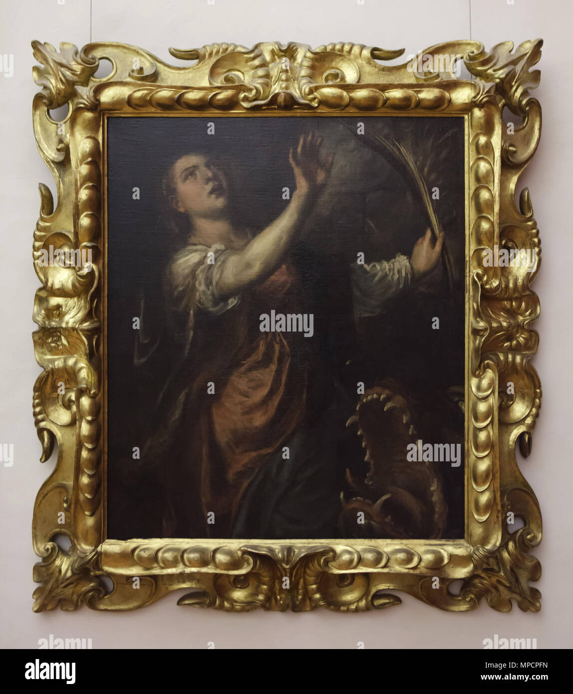 'Saint peinture Margaret" (1565-1570) par le peintre de la Renaissance italienne Tiziano Vecellio également connu sous le nom de Titien exposé dans la galerie des Offices (Galleria degli Uffizi), à Florence, Toscane, Italie. Banque D'Images