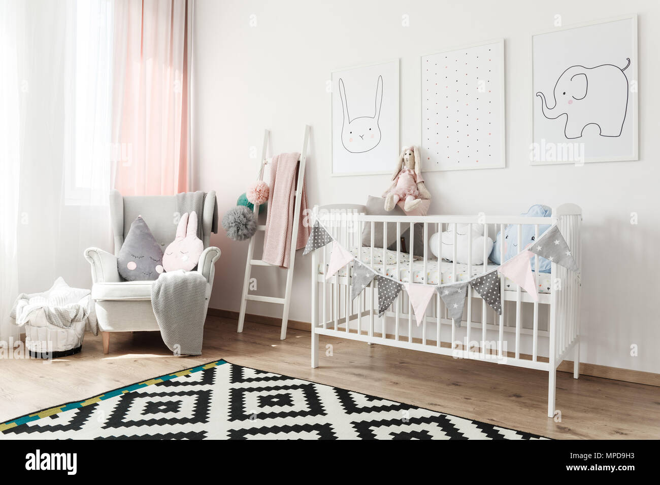 Tapis noir et blanc en scandi chambre d'enfant avec lit blanc, fauteuil  gris et remonte avec pompons Photo Stock - Alamy