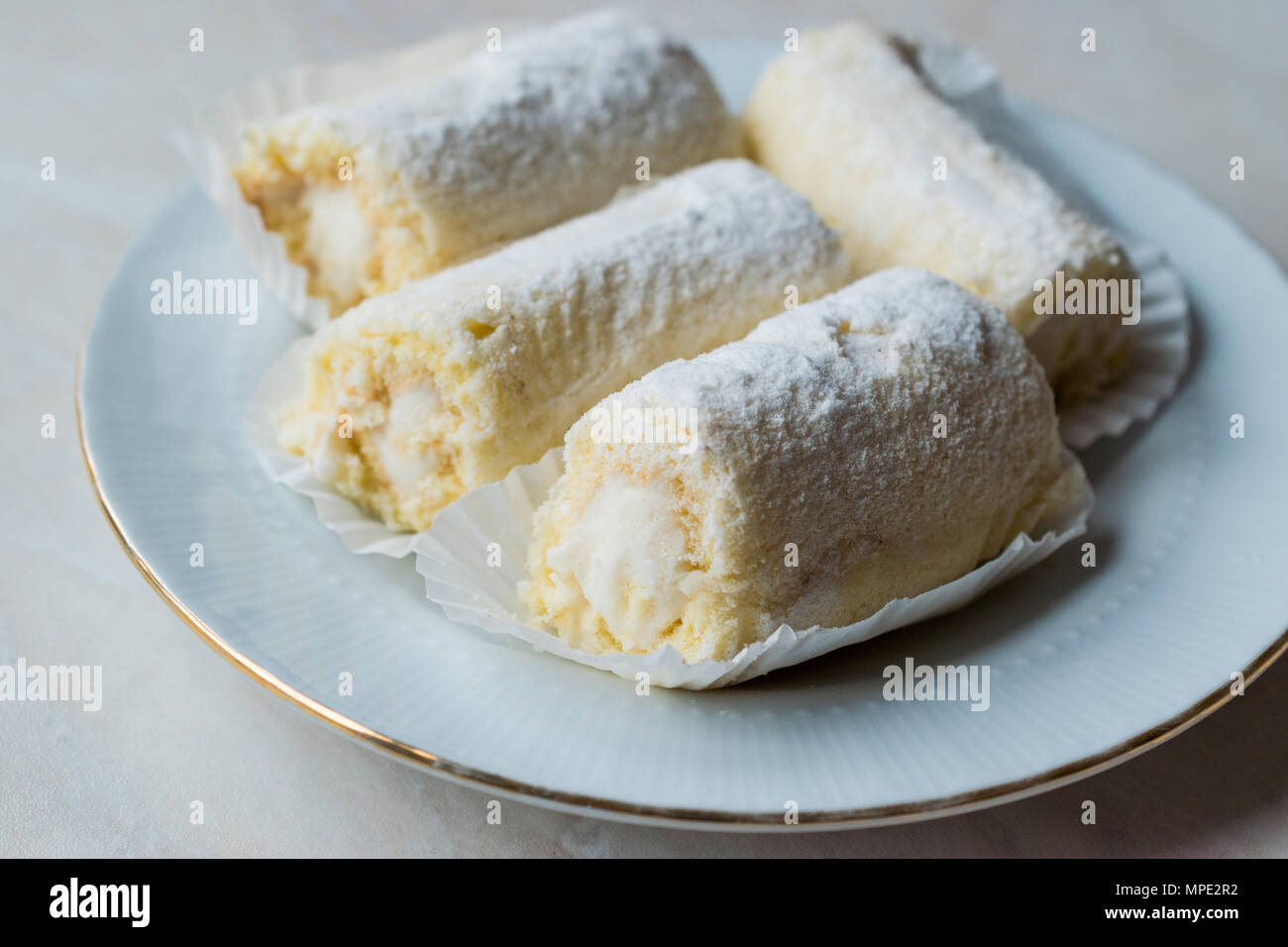 Rouleau Mini Gâteau à la crème de vanille, noix de coco et de sucre en poudre. Concept de dessert. Banque D'Images