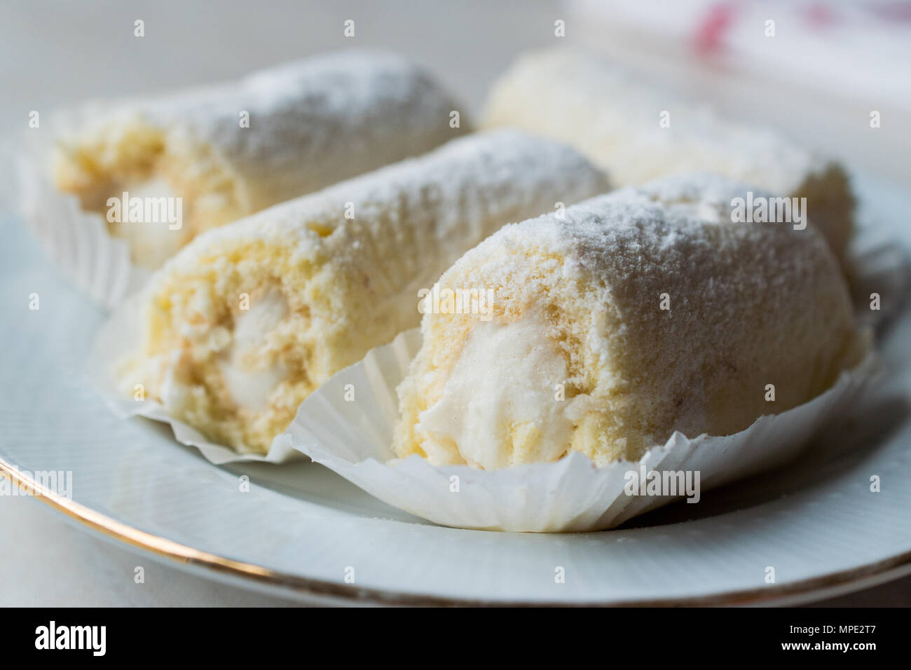 Rouleau Mini Gâteau à la crème de vanille, noix de coco et de sucre en poudre. Concept de dessert. Banque D'Images