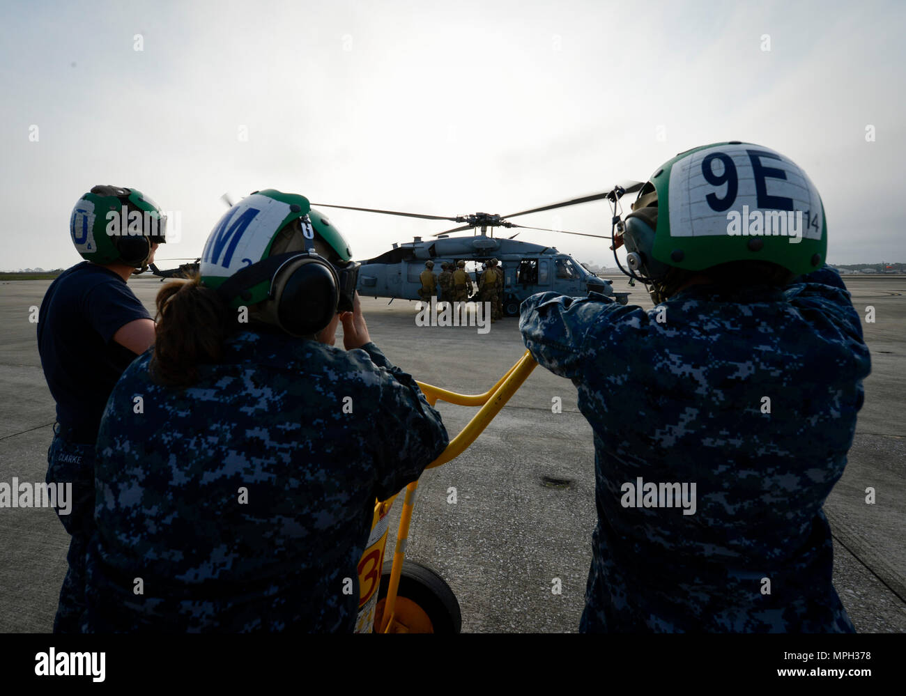 Les marins de la Marine américaine à partir d'hélicoptères de combat de la mer 5 l'Escadron Français regardez comme des forces d'opérations spéciales de l'Armée de l'air à bord d'un MH-60S Seahawk pendant 17 Emerald Warrior 1 mars 2017, à Hurlburt Field, Floride Emerald Warrior est un commandement des opérations spéciales des États-Unis au cours de l'exercice qui joint Special operations forces canadiennes s'entraînent pour répondre aux différentes menaces dans toute la gamme des conflits. (U.S. Photo de l'Armée de l'air par le sergent. Michael batailles) Banque D'Images