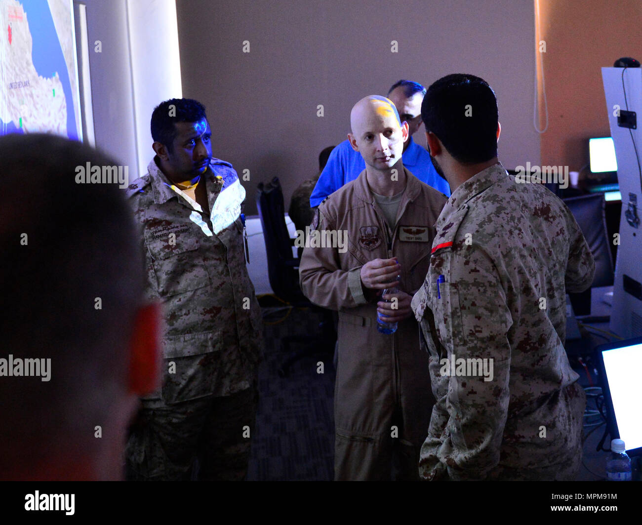 Us Air Forces Central Command Le Capitaine Trent Davis (centre) se tient dans l'éclat d'un projecteur lumière discuter de missiles balistiques simulé avec les officiers Koweïtiens, 27 mars 2017, au cours de la phase de l'exercice de poste de commandement Eagle résoudre au Koweït. Eagle exercice résoudre est le premier exercice multilatéral des États-Unis au sein de la péninsule arabique. Depuis 1999, Eagle Résoudre est devenu le premier engagement entre les États-Unis et le Conseil de coopération du Golfe nations pour répondre collectivement les défis régionaux associés à la guerre asymétrique dans un établissement à faible risque. Banque D'Images