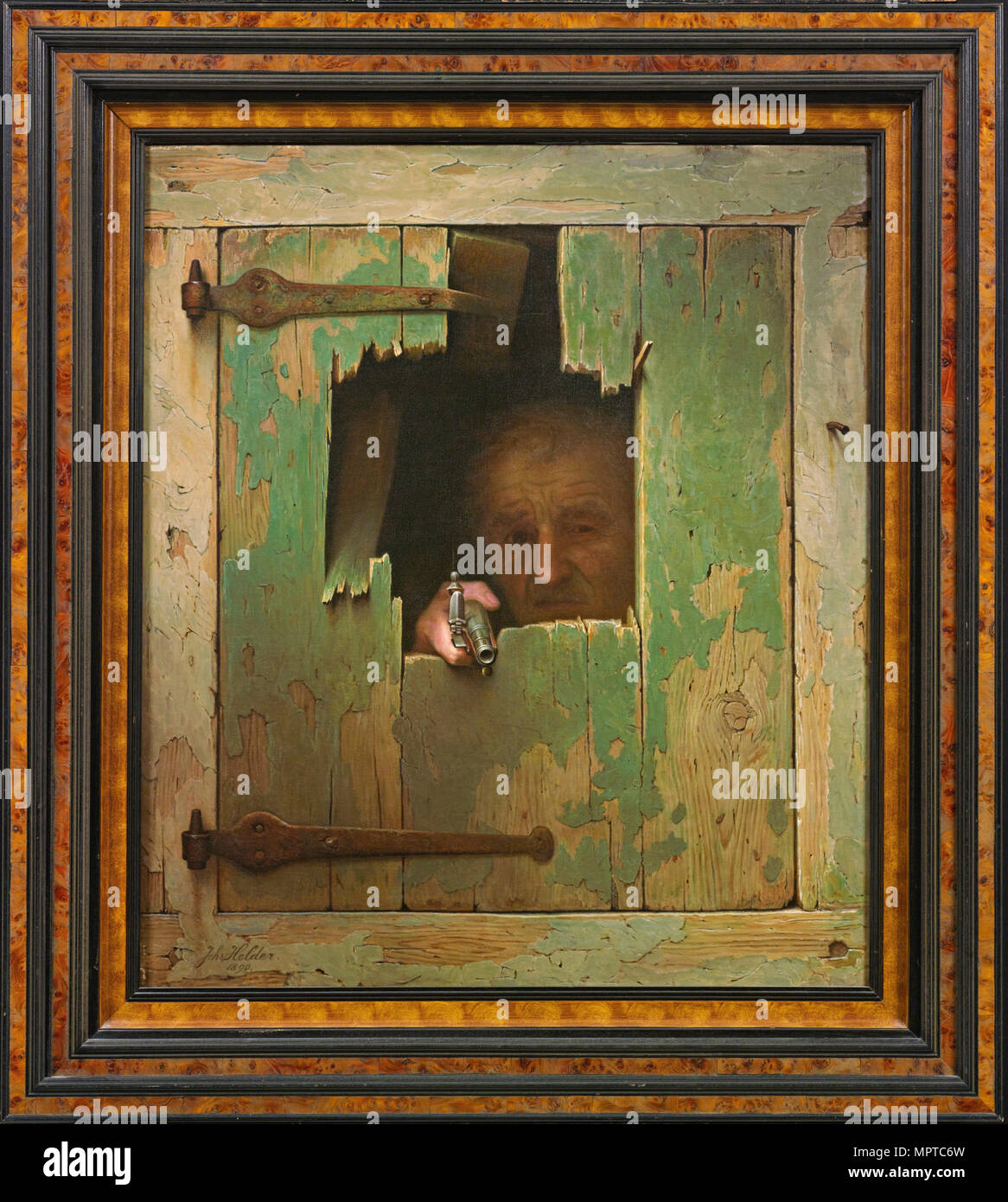 Homme avec un pistolet d'argent. Banque D'Images