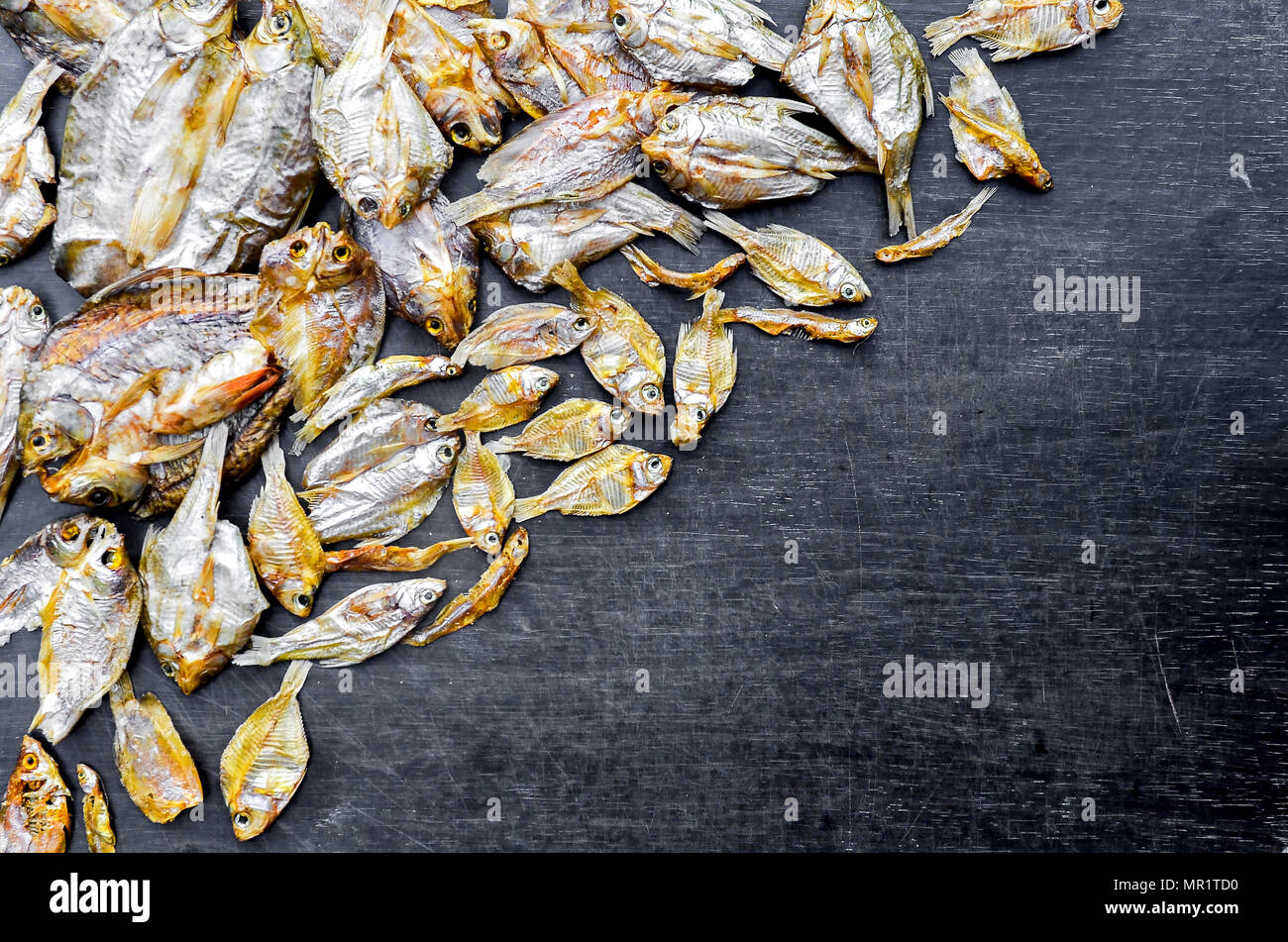 Le poisson sec et ensoleillé sur plancher en bois noir, de petits poissons séchés et le modèle de poisson séché, vue de dessus de sécher le poisson sur la table Banque D'Images