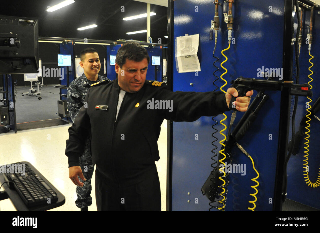 170503-N-SL853-083, GRANDS LACS Il. (Mai 03, 2017) Le Cmdr. Jorge Toso, Marine chilienne, tire un 9 mm Baretta (modification) à l'adresse au tir d'armes simulés au cours d'un formateur d'agents étrangers 3 mai, à recruter le commandement de l'instruction. La visite comprenait quatre hauts membres de la liaison avec l'étranger à partir de la flotte américaine de commandement des Forces canadiennes qui ont visité le service naval de la RTC et Formation Support Centre sur une période de trois jours. Les officiers étaient représentant le Mexican, brésilien, chilien, péruvien et marines. À propos 30,000-40 000 recrues par année d'études supérieures de la marine est que boot camp. (U.S. Photo par Marine Gaz Chef Tur Banque D'Images