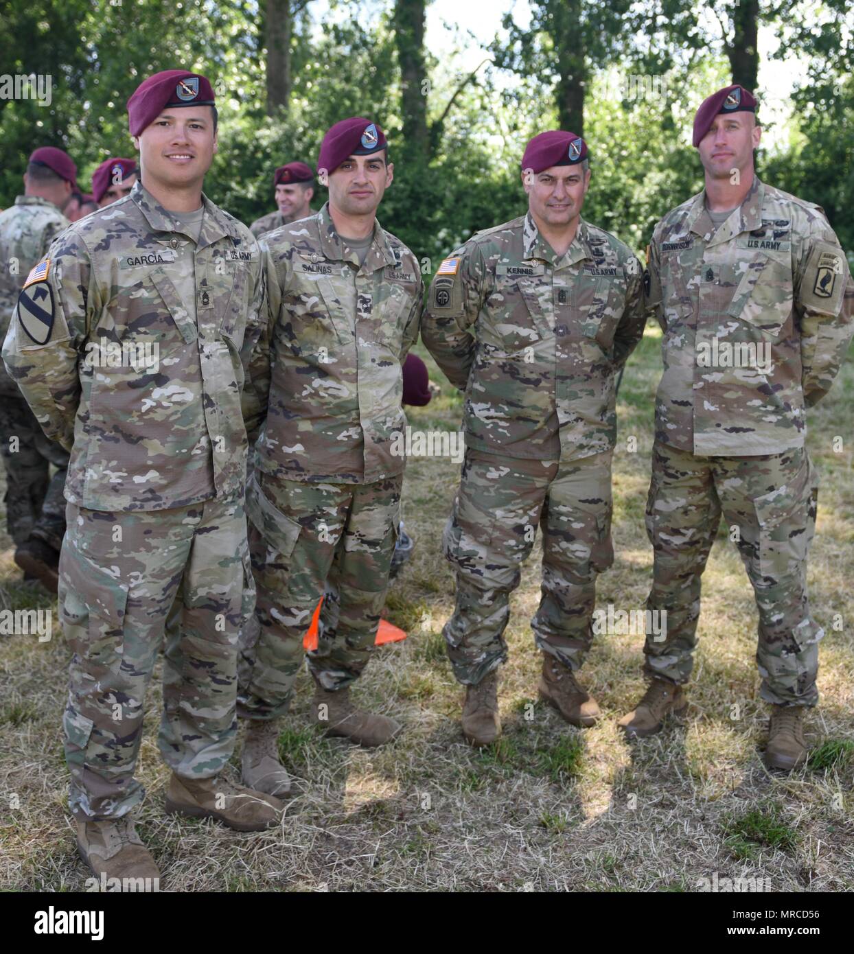 Les parachutistes de l'armée américaine, du 1er bataillon du 143e Régiment d'infanterie (Texas Army National Guard), la 173e Brigade aéroportée stand au tour de parachute dans le domaine à la suite de l'opération aéroportée commémorative sur Iron Mike Drop Zone II en Normandie, France. De l'ensemble des parachutistes des Forces armées et de l'OTAN a sauté en Normandie pour commémorer le 73e anniversaire de l'opération Overlord, également connu sous le nom de D-Day. La 173e Brigade aéroportée (Sky) Des soldats de l'armée américaine est la force de réaction d'urgence en Europe, fournissant des forces rapides vers les États-Unis, d'Europe centrale et l'Afrique les zones de commandes respo Banque D'Images