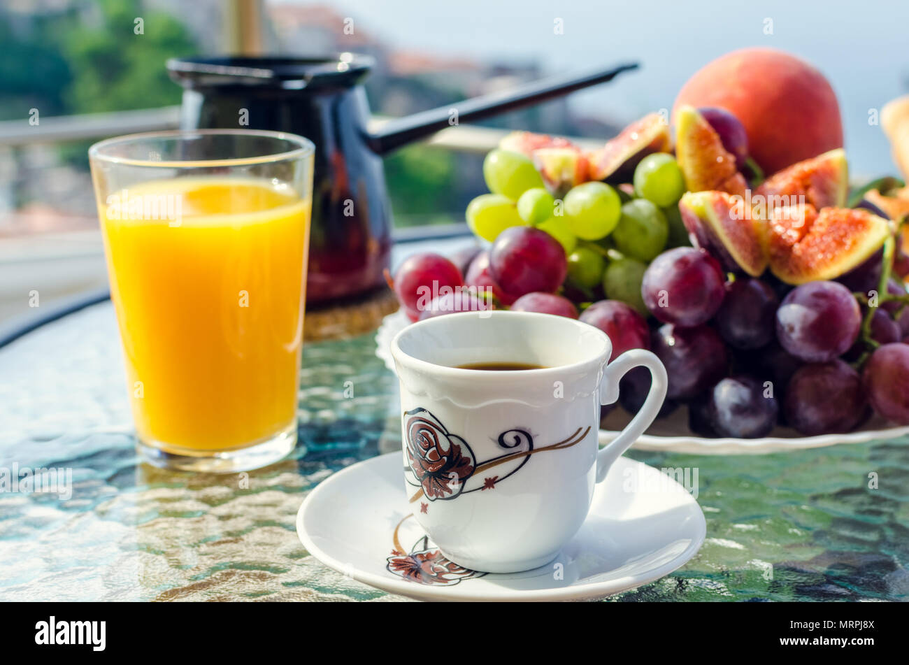 Petit déjeuner sain sur la table avec une tasse de café, un verre de jus d'orange, une plaque de la bourgogne blanc et raisins, figues, de pêche et de café turc Banque D'Images