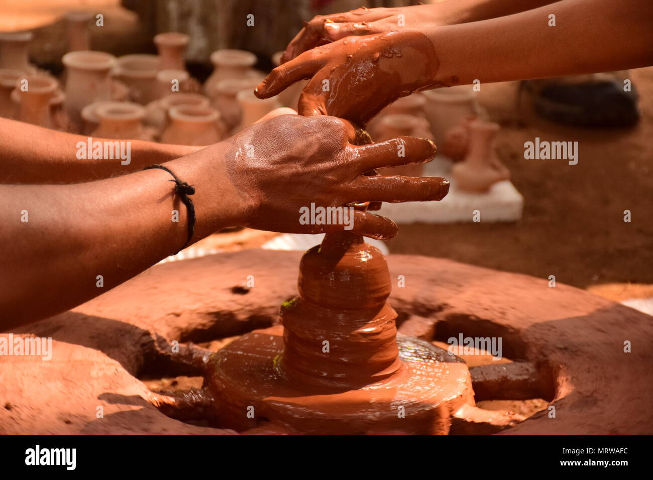 Faire potter traditionnels indiens pot en argile sur roue de poterie Banque D'Images